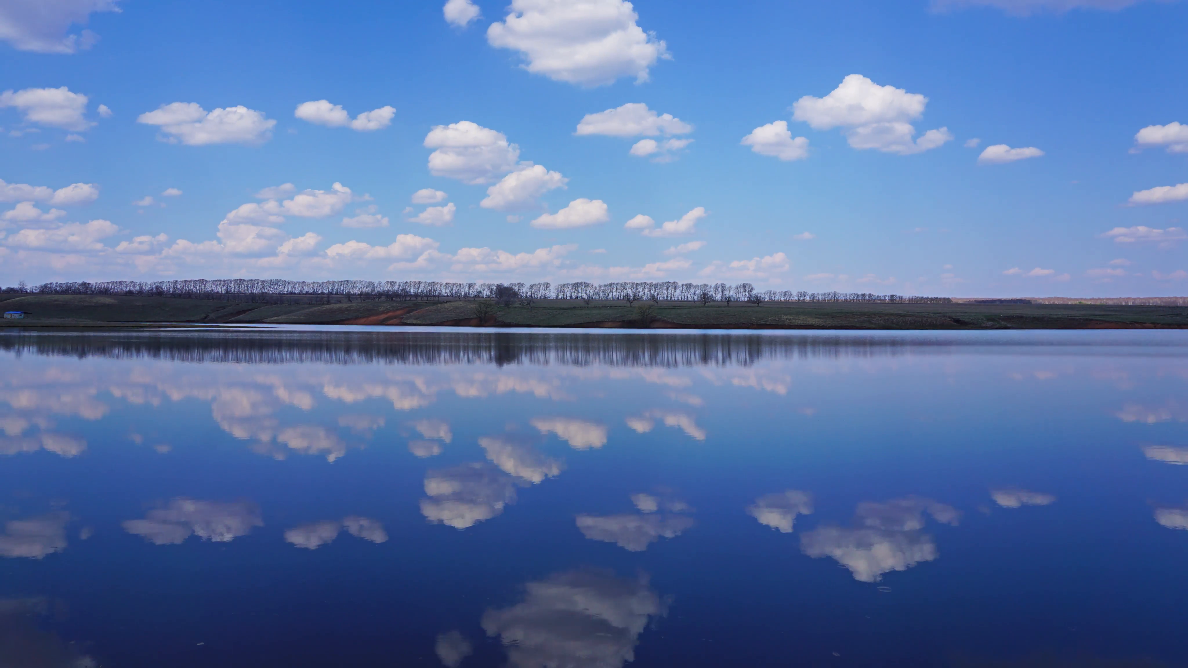 Clouds are reflected in smooth water of lake - timelapse, 4k Stock ...