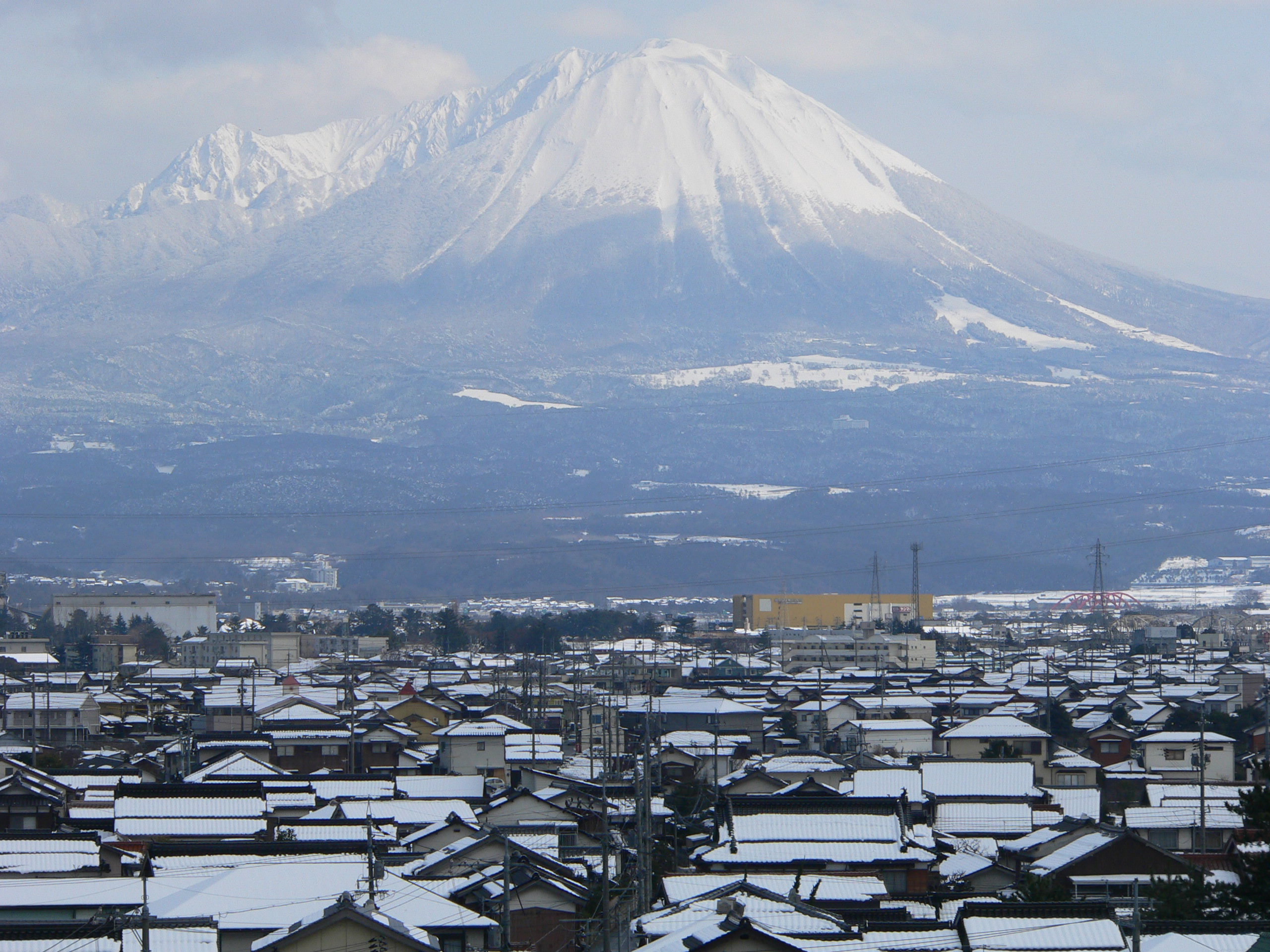 Snow capped mount daisen with yonago in foreground photo