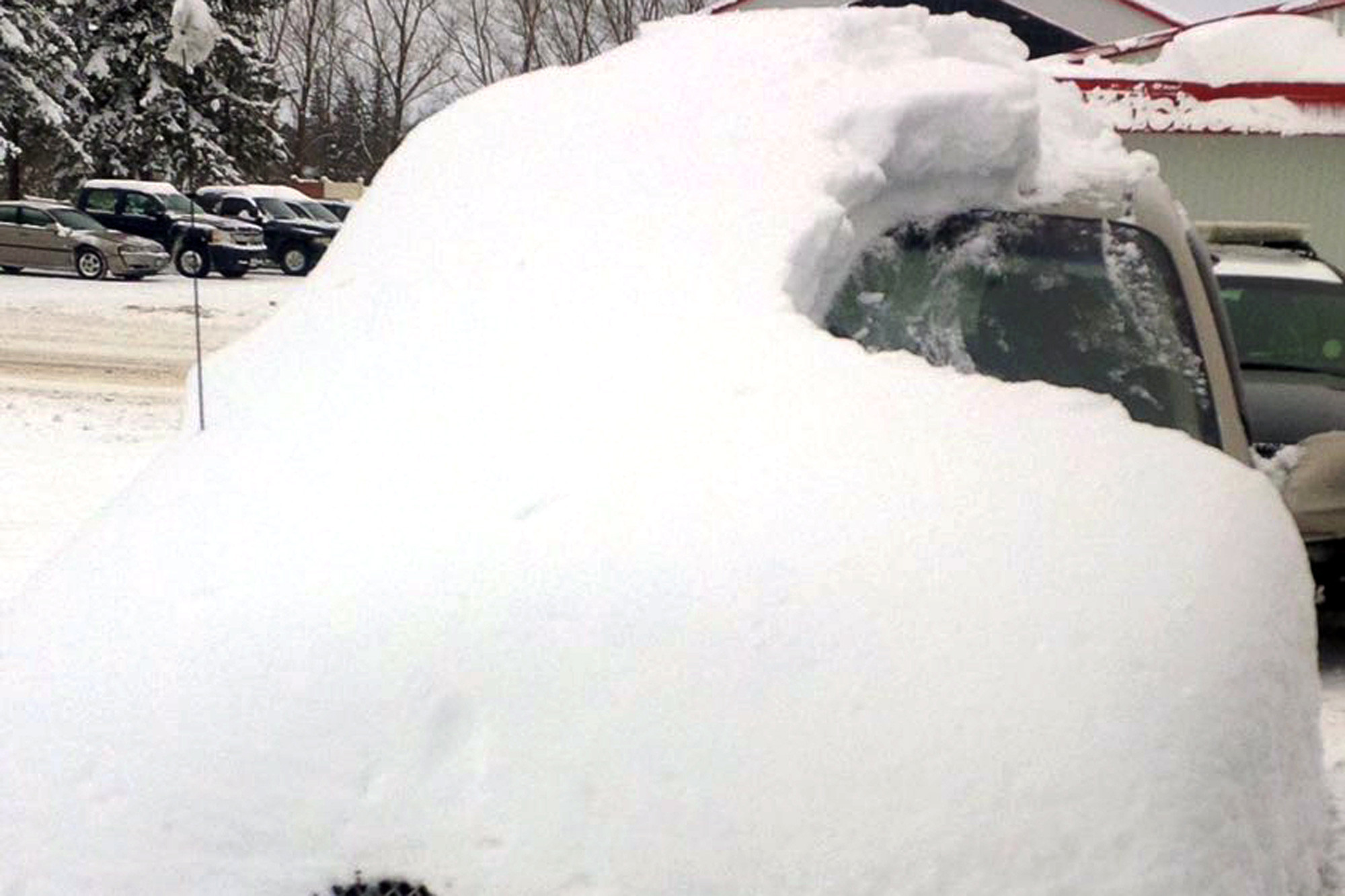 Old man charged after driving car almost completely covered in snow