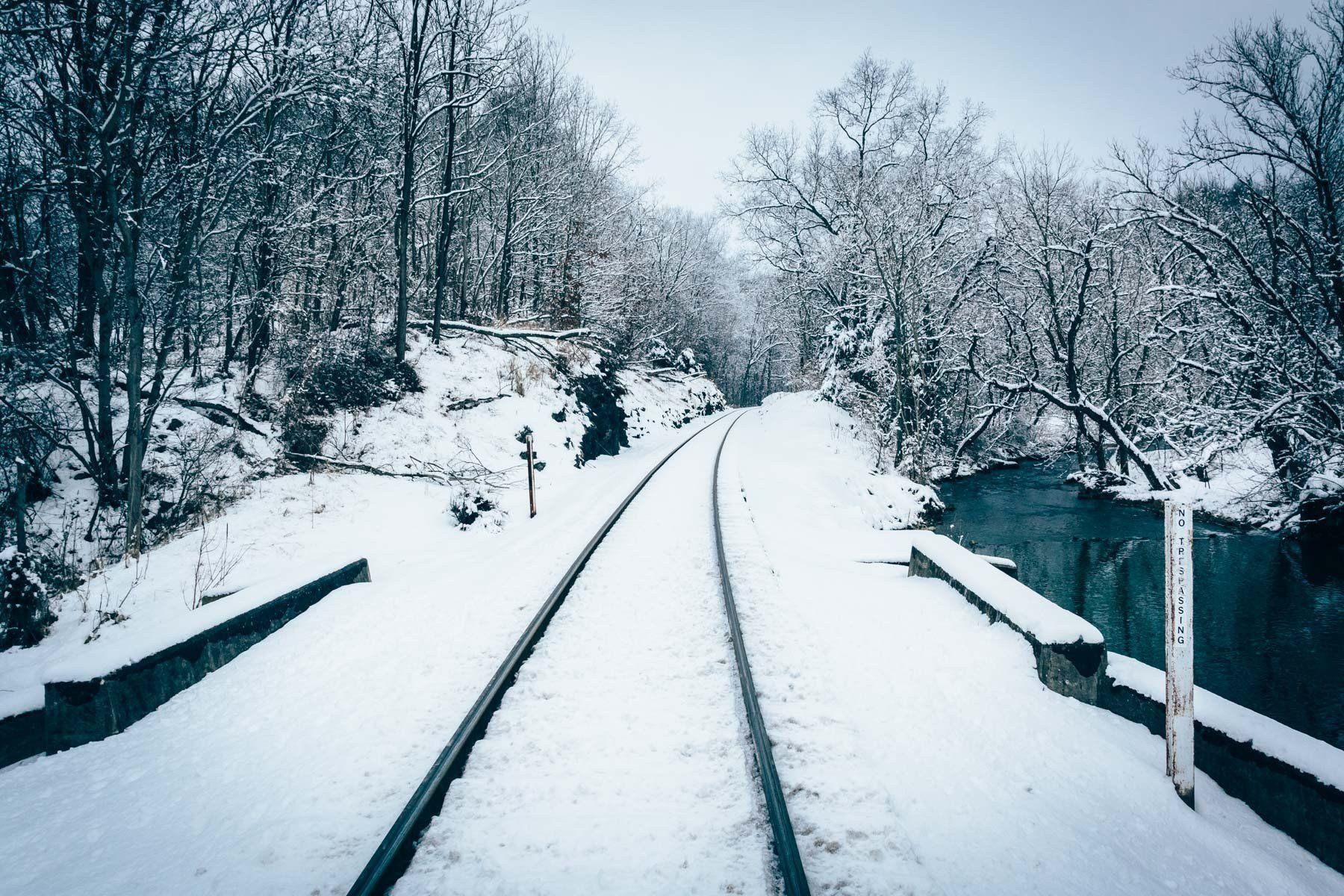 A snow covered railroad track and creek in rural Carroll County ...