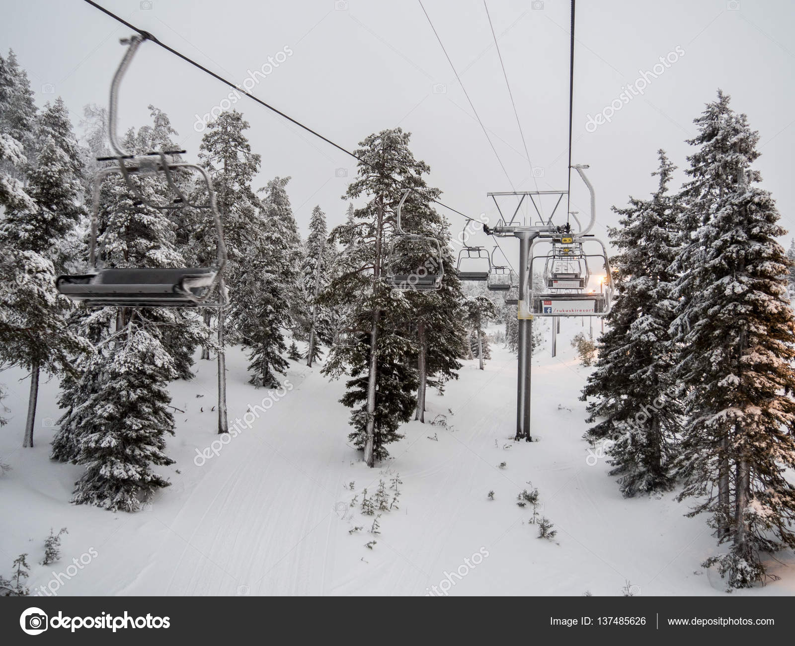 RUKA, FINLAND - JANUARY 2017: Ski lift with seats going over the ...