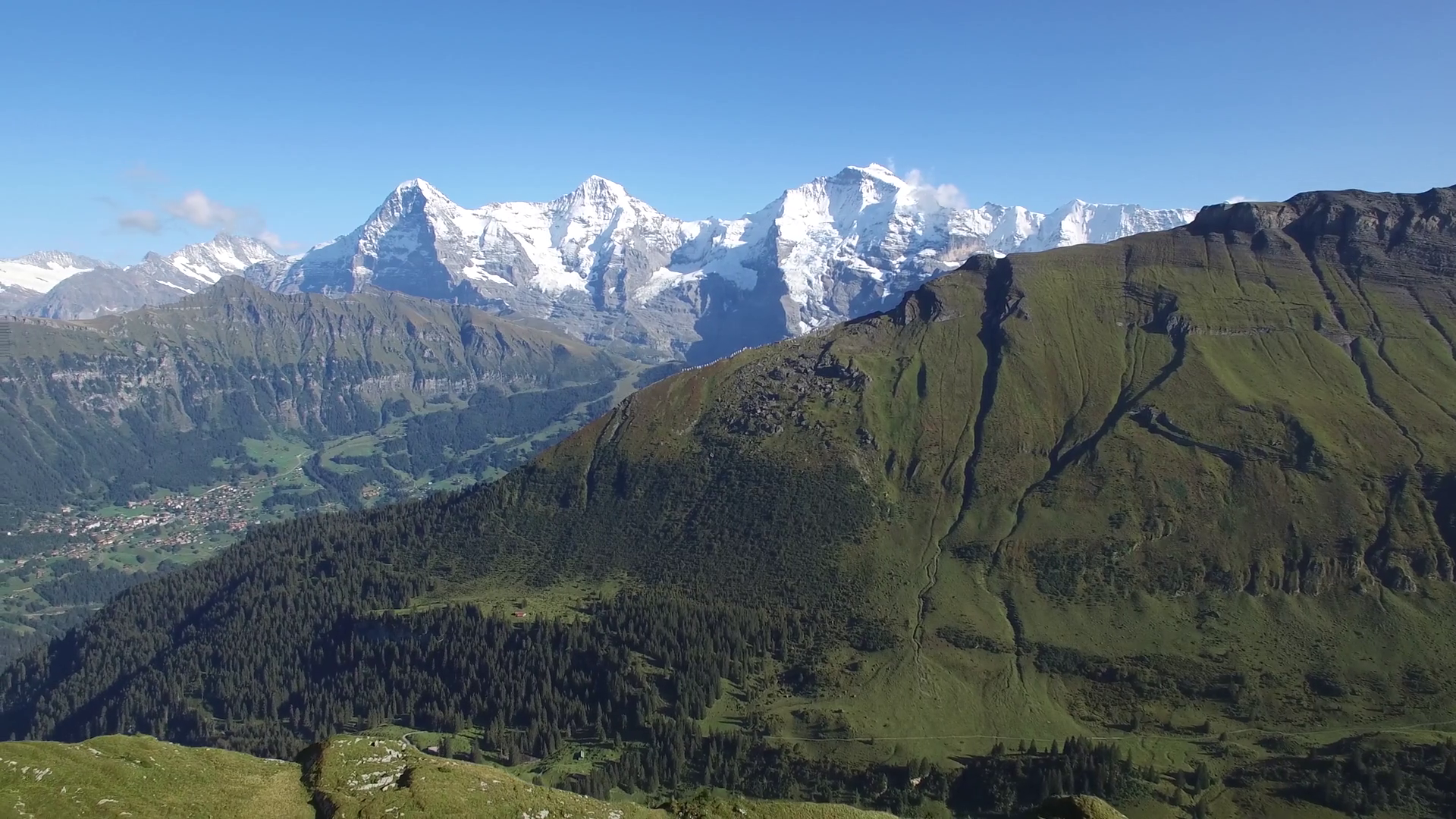 AERIAL DOLLY SHOT OF HIKERS WITH SNOW CAP MOUNTAINS INTERLAKEN Stock ...