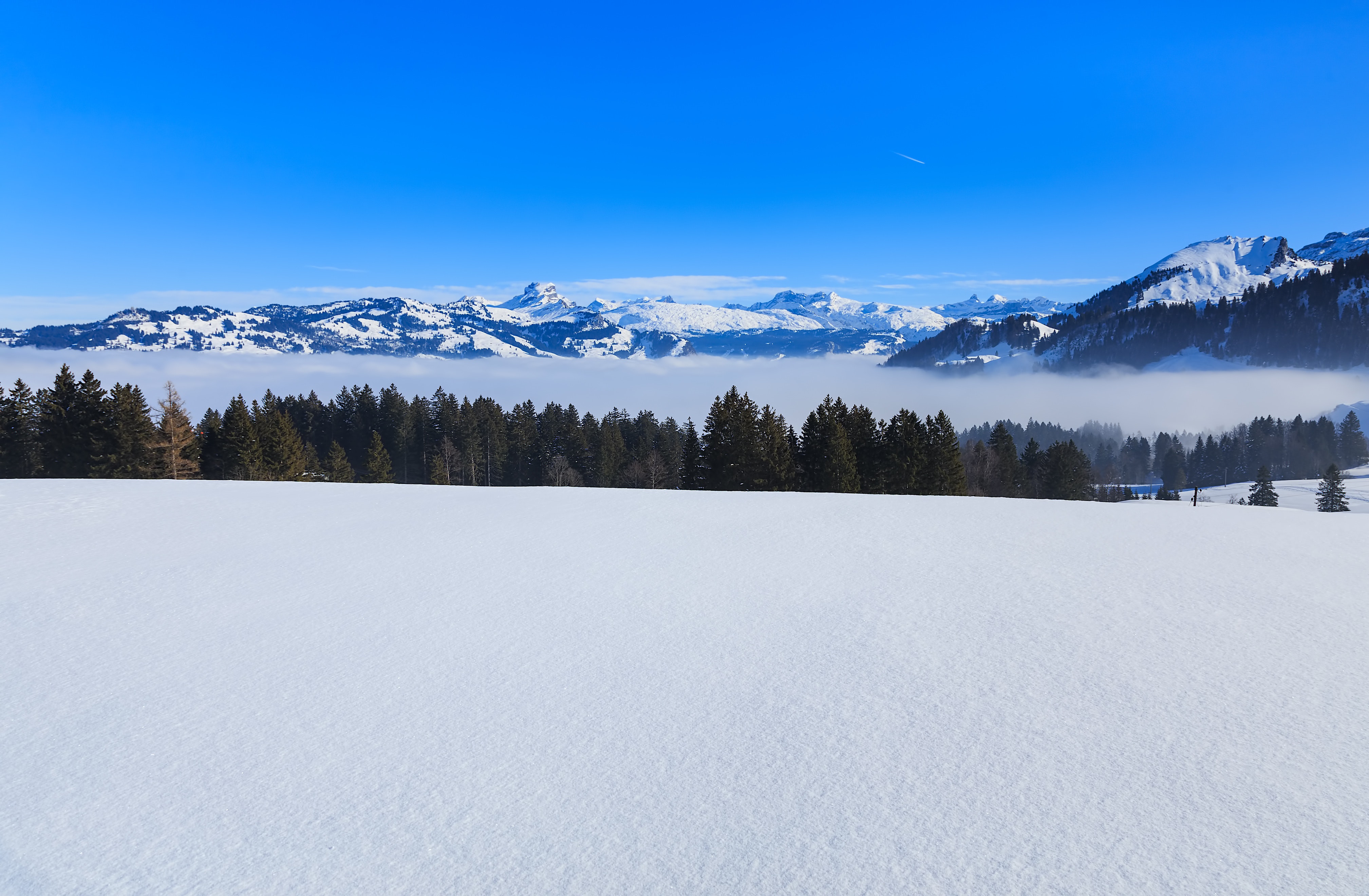 Snowy mountain under blue sky photo