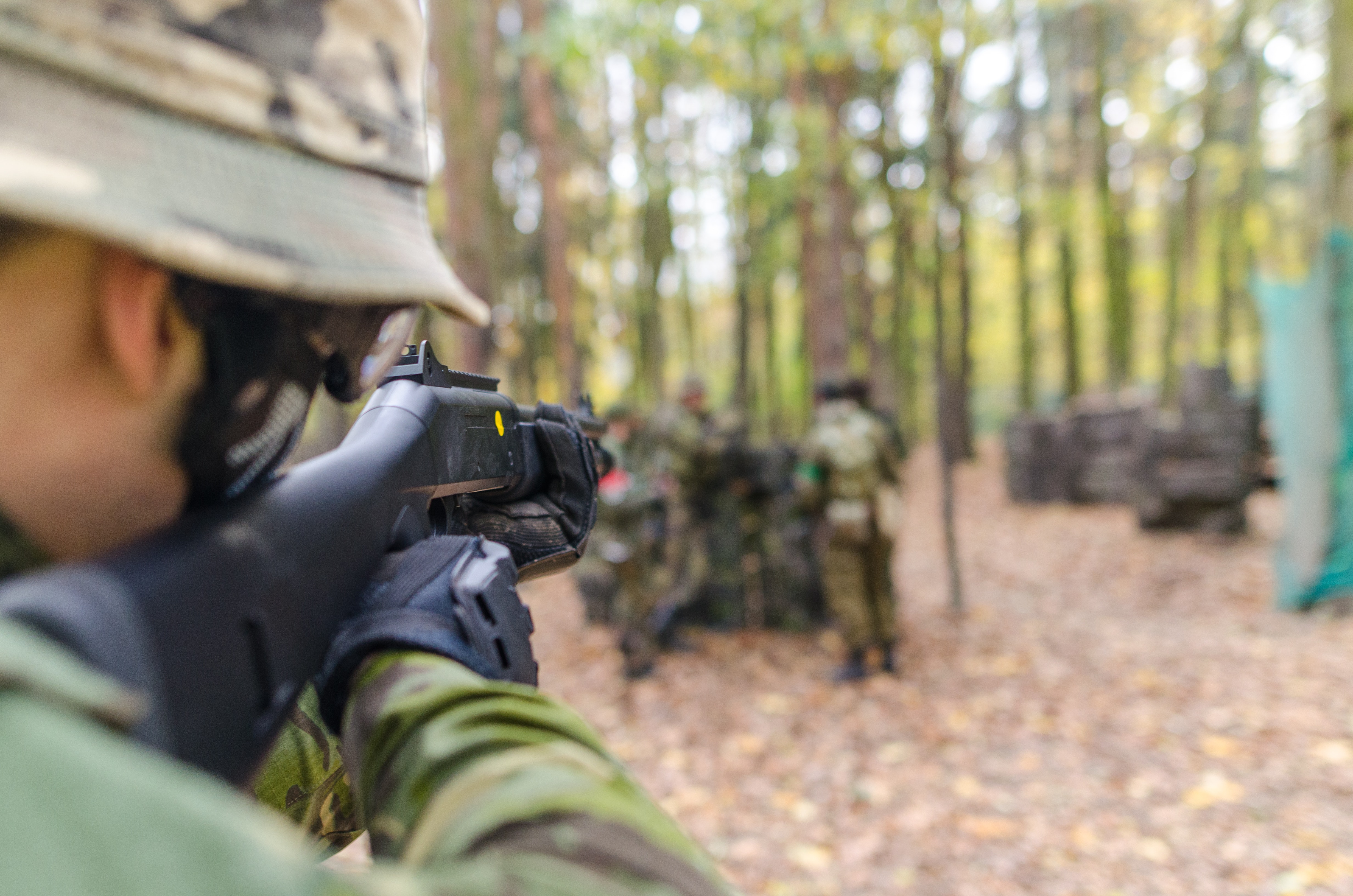 Soldier holding black assault rifle photo