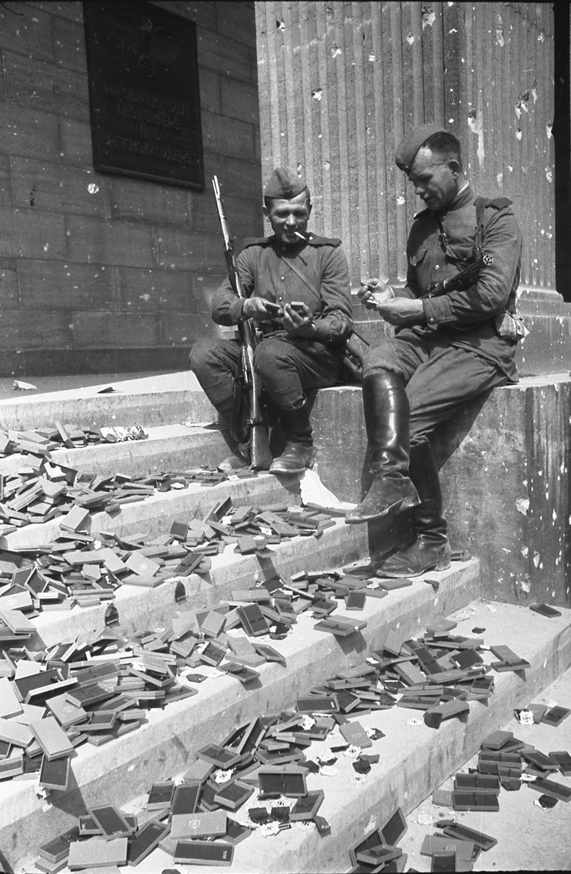 Soviet soldiers resting on the steps of the Reich Chancellery ...