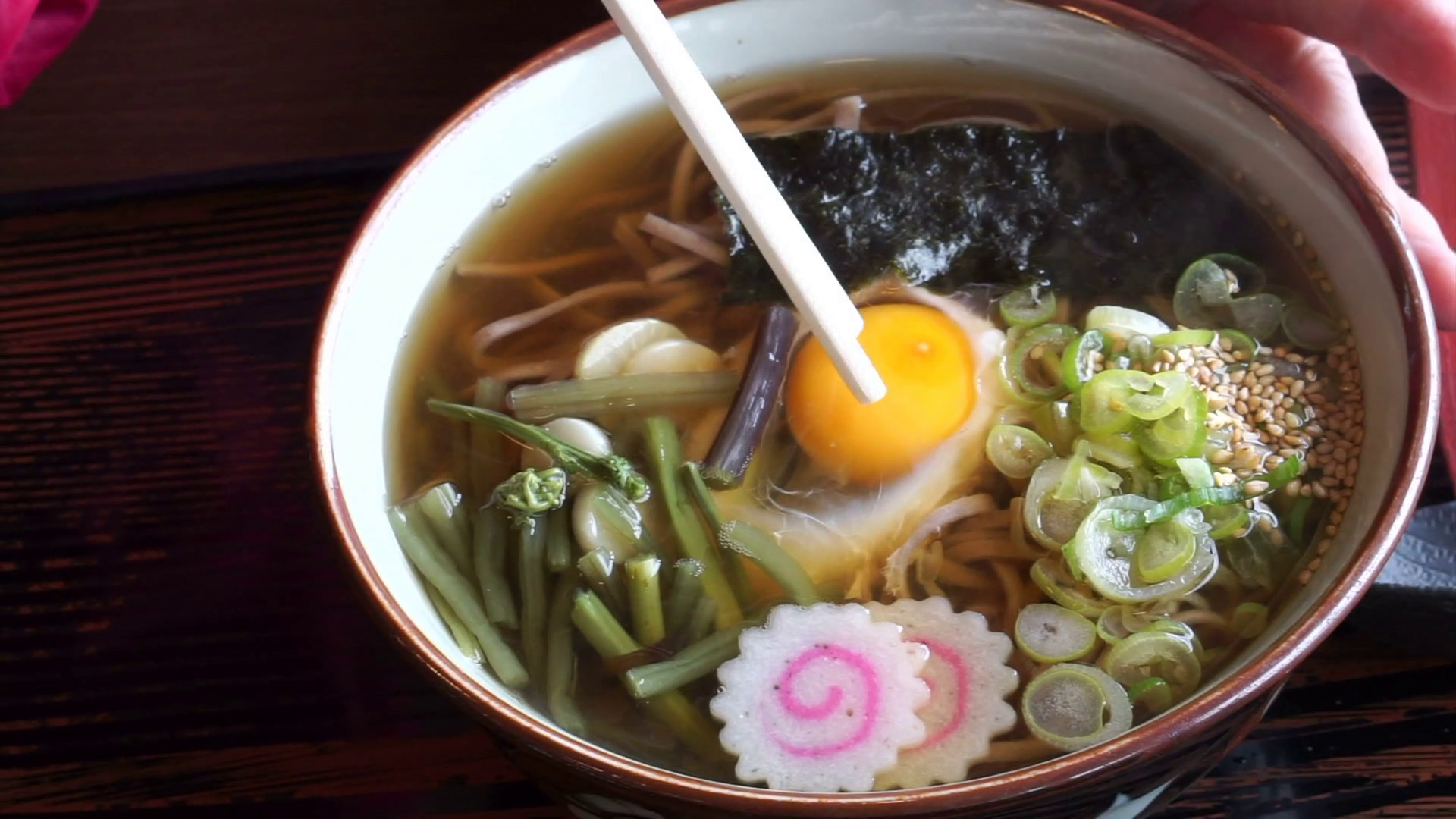 Hand eating Japanese soba noodle hot soup, using chopsticks to ...