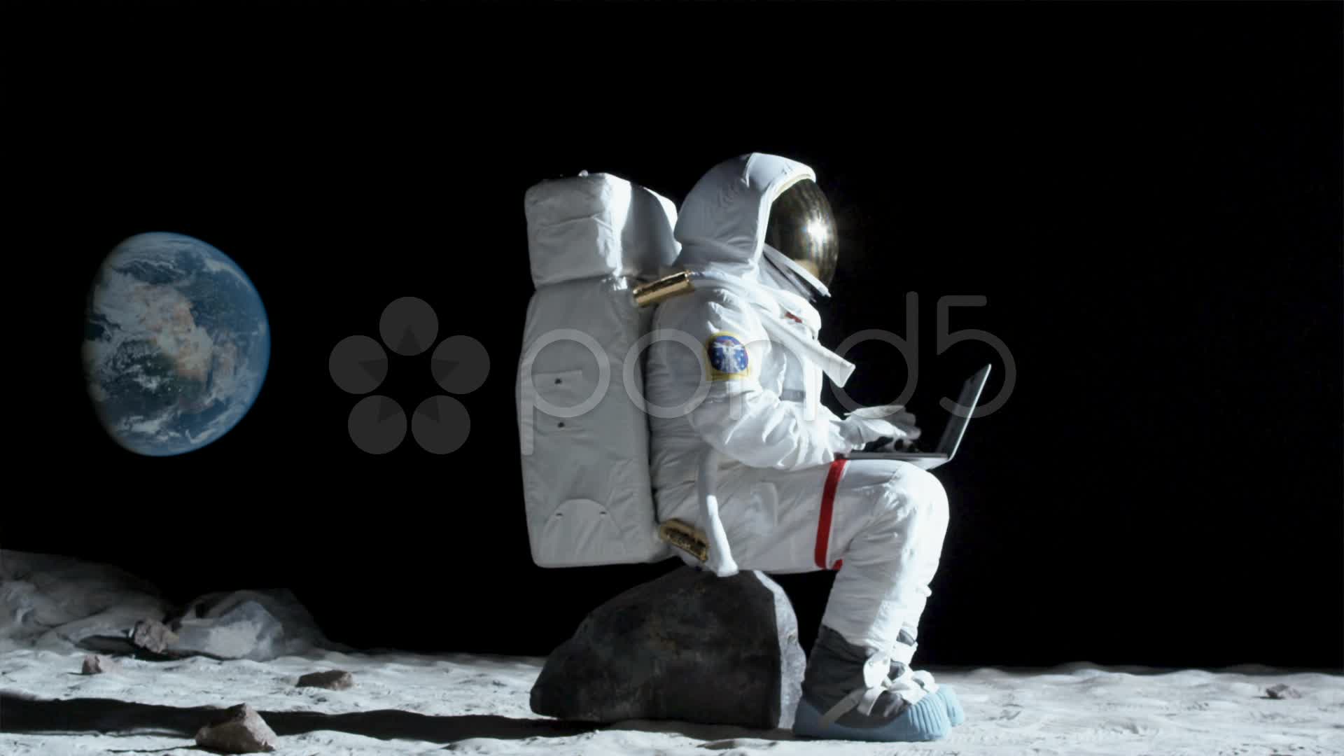 SLO MO, WS, Lockdown of an astronaut sitting on a rock on the moon ...