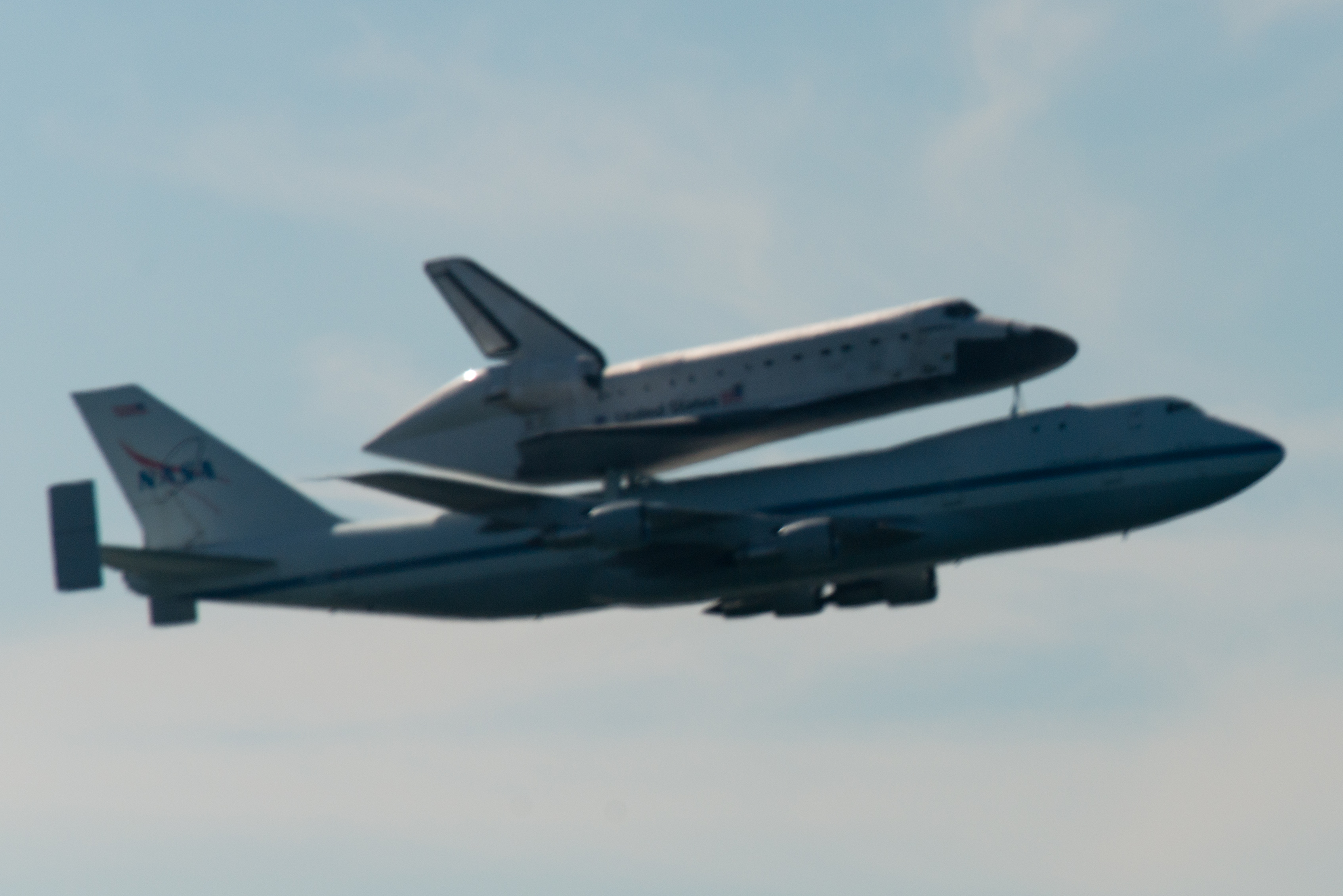 Space shuttle endeavour and carrier plane flying over san francisco bay - profile view photo