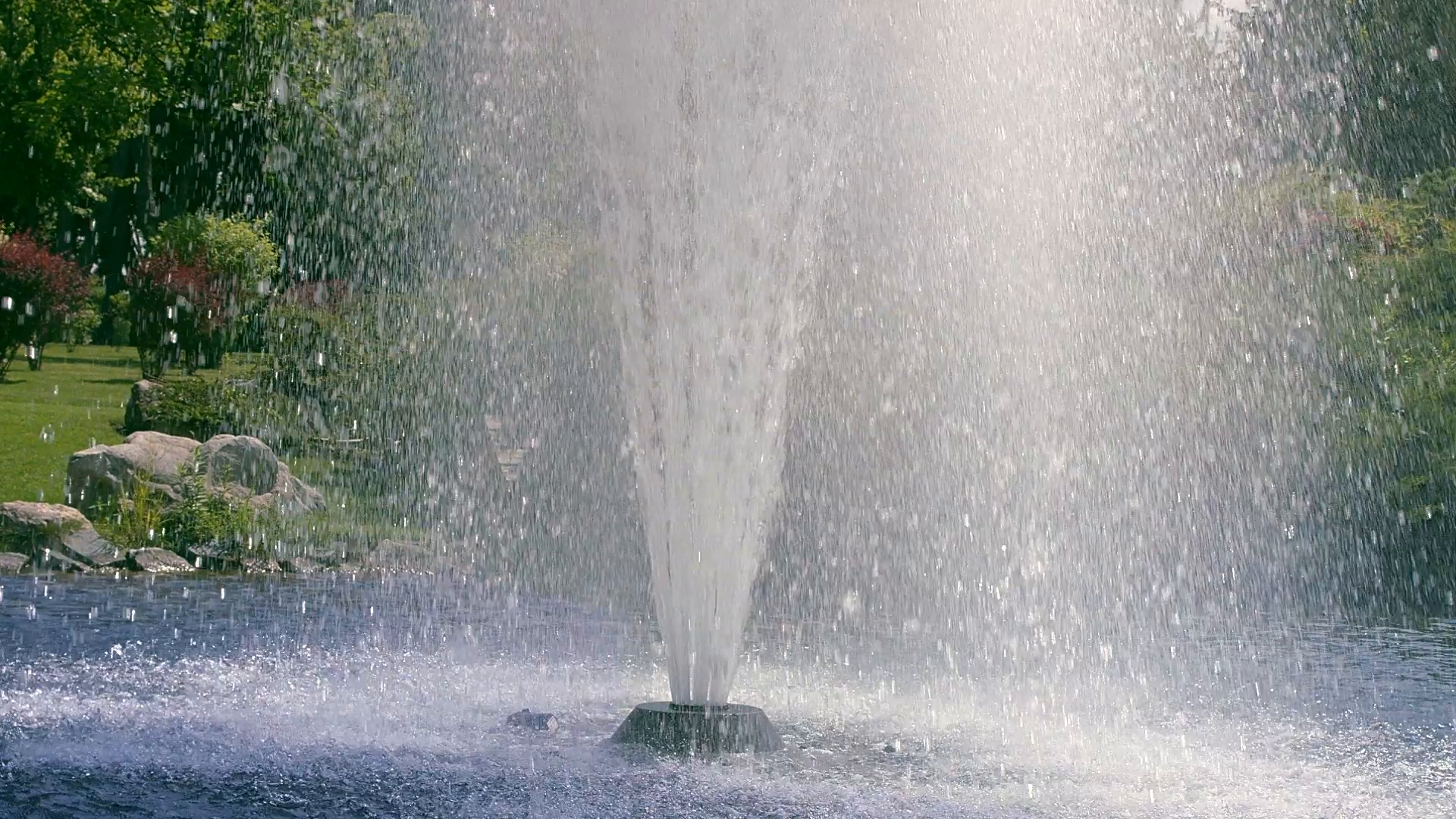 Fountain water in slow motion. Beautiful high fountain in garden ...