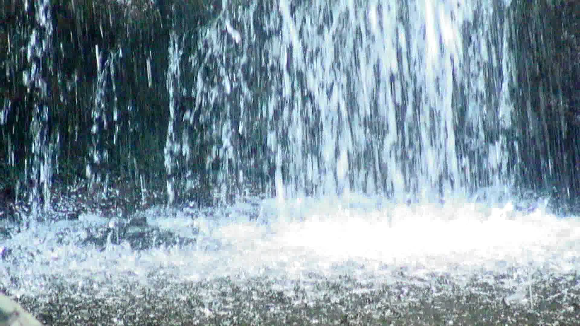 Water from a waterfall splashing into a pond. - YouTube