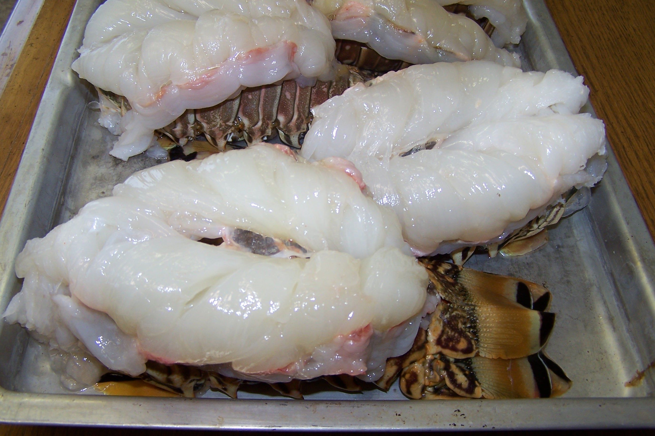 Split lobster tails in pan photo