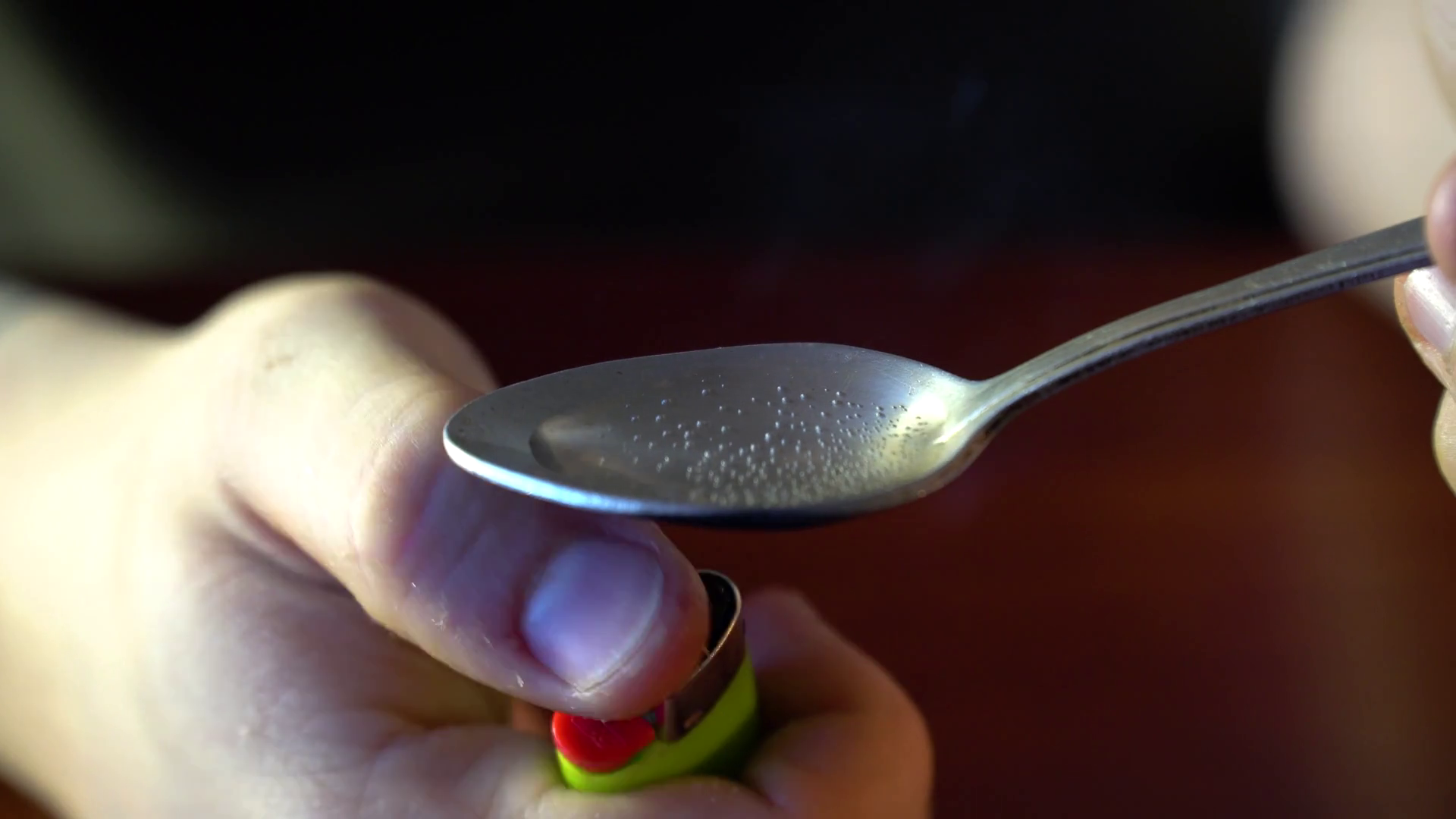 Man Preparing Dose Of cocaine by heating it with lighter in spoon ...