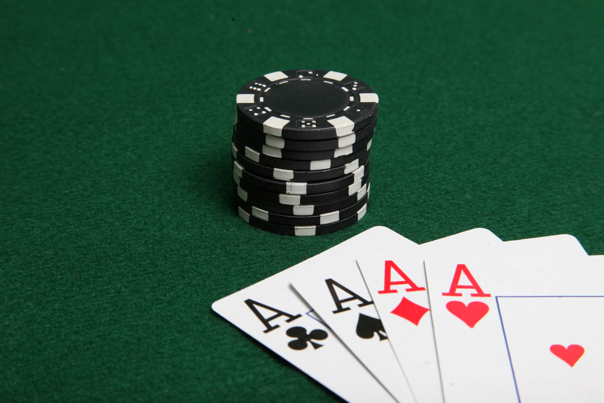 Stack of black poker chips with four ace photo