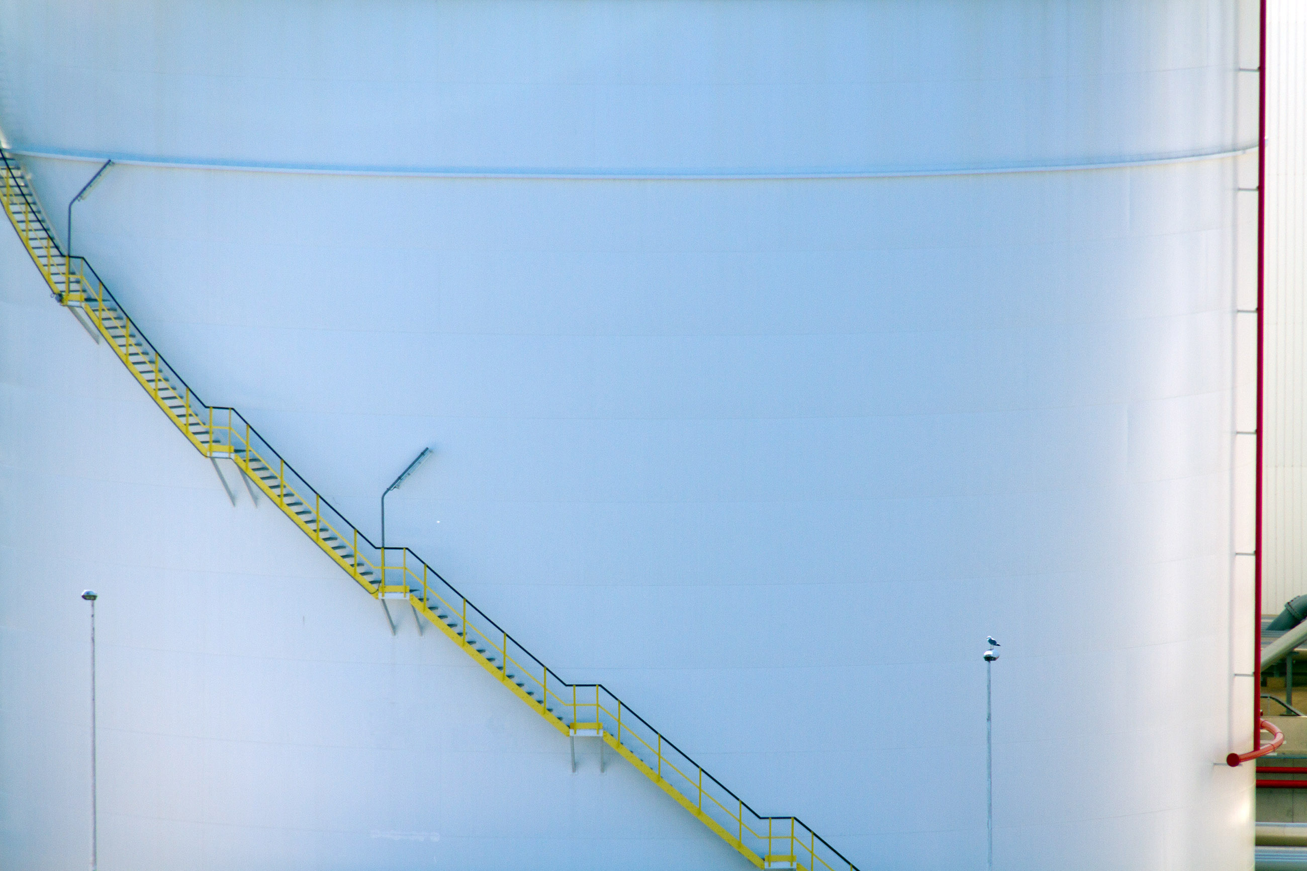 Stairs on the side of an oil storage tank photo