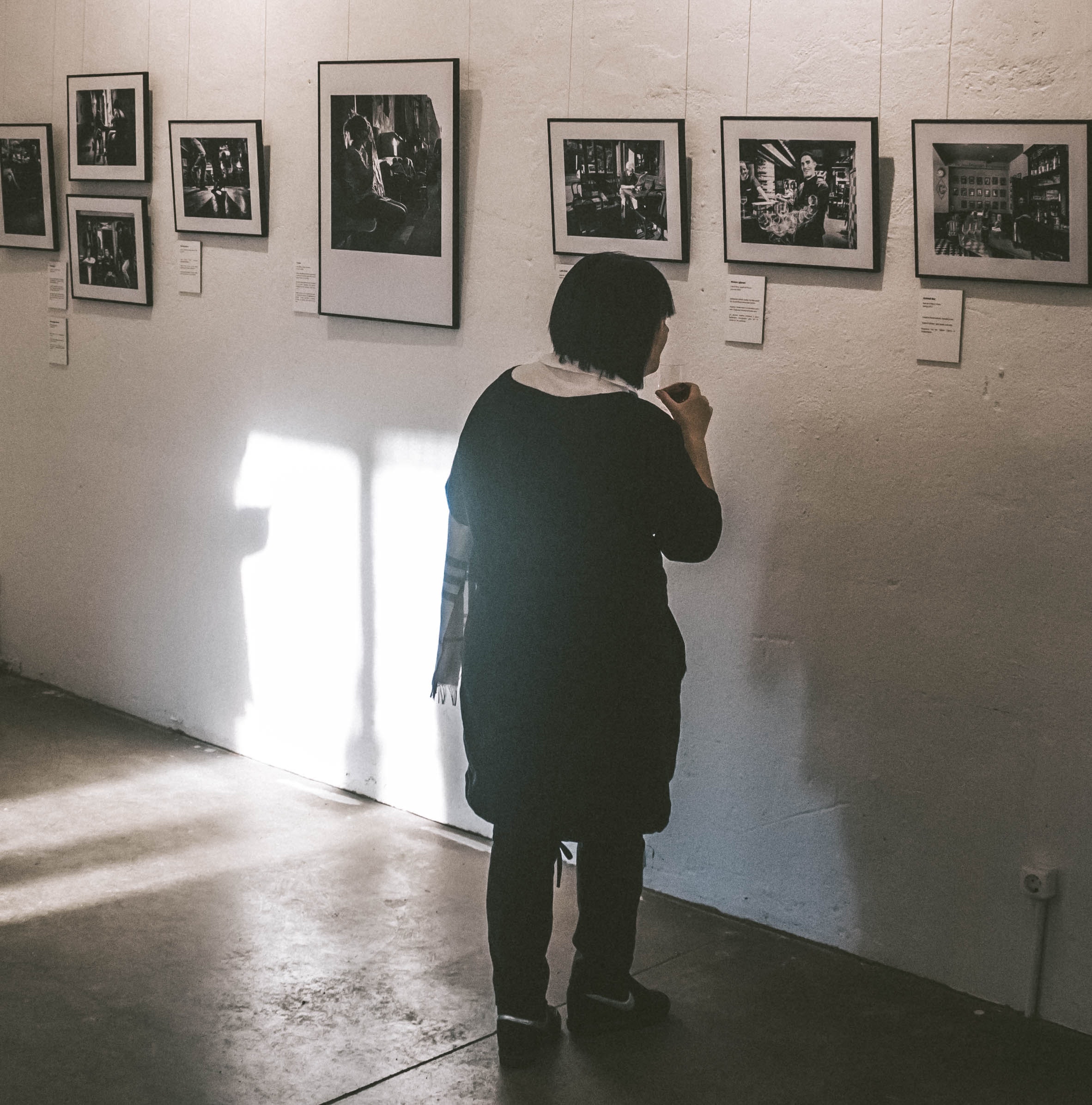 Standing woman looking at photos