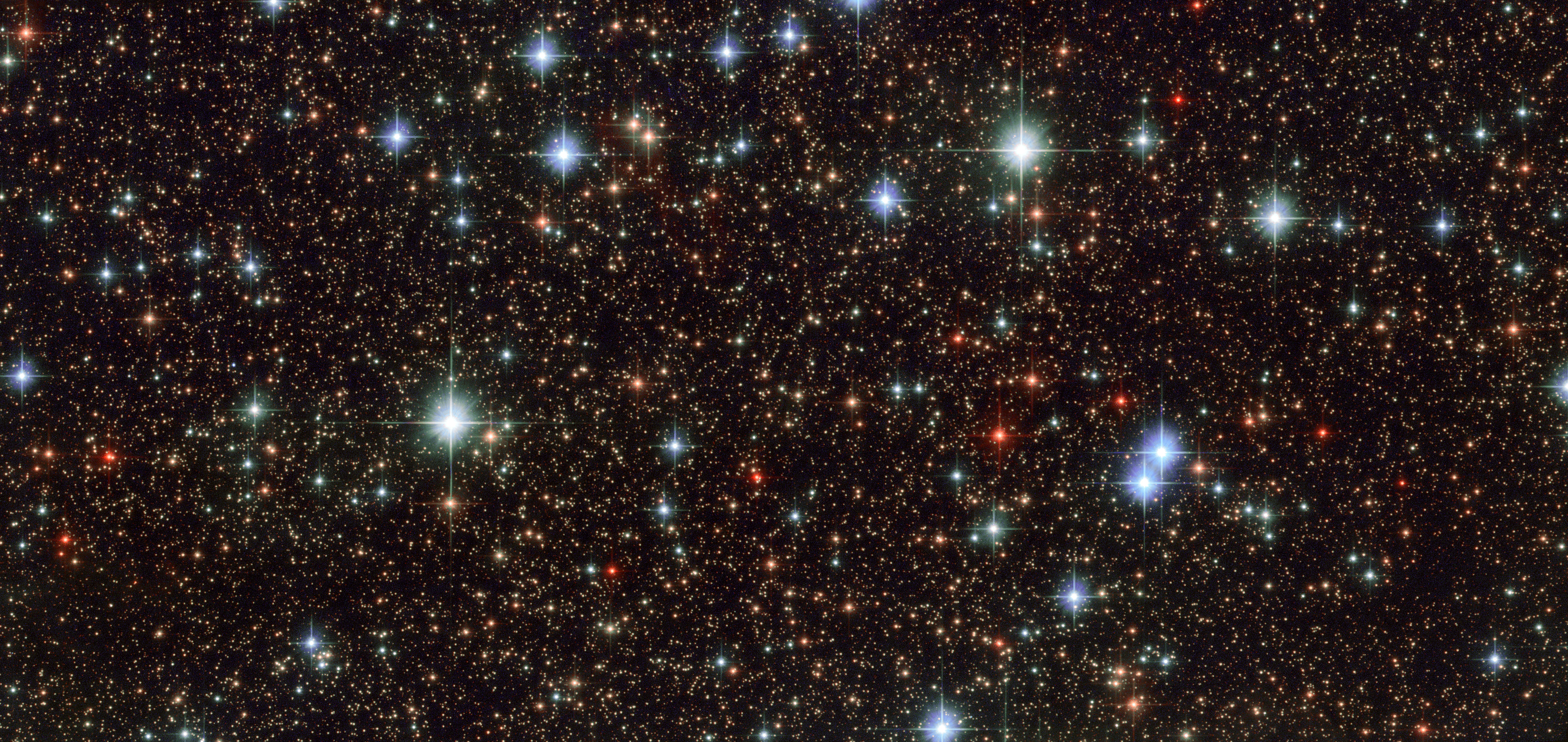 Hubble photo of the galactic center reveals colorful stars.