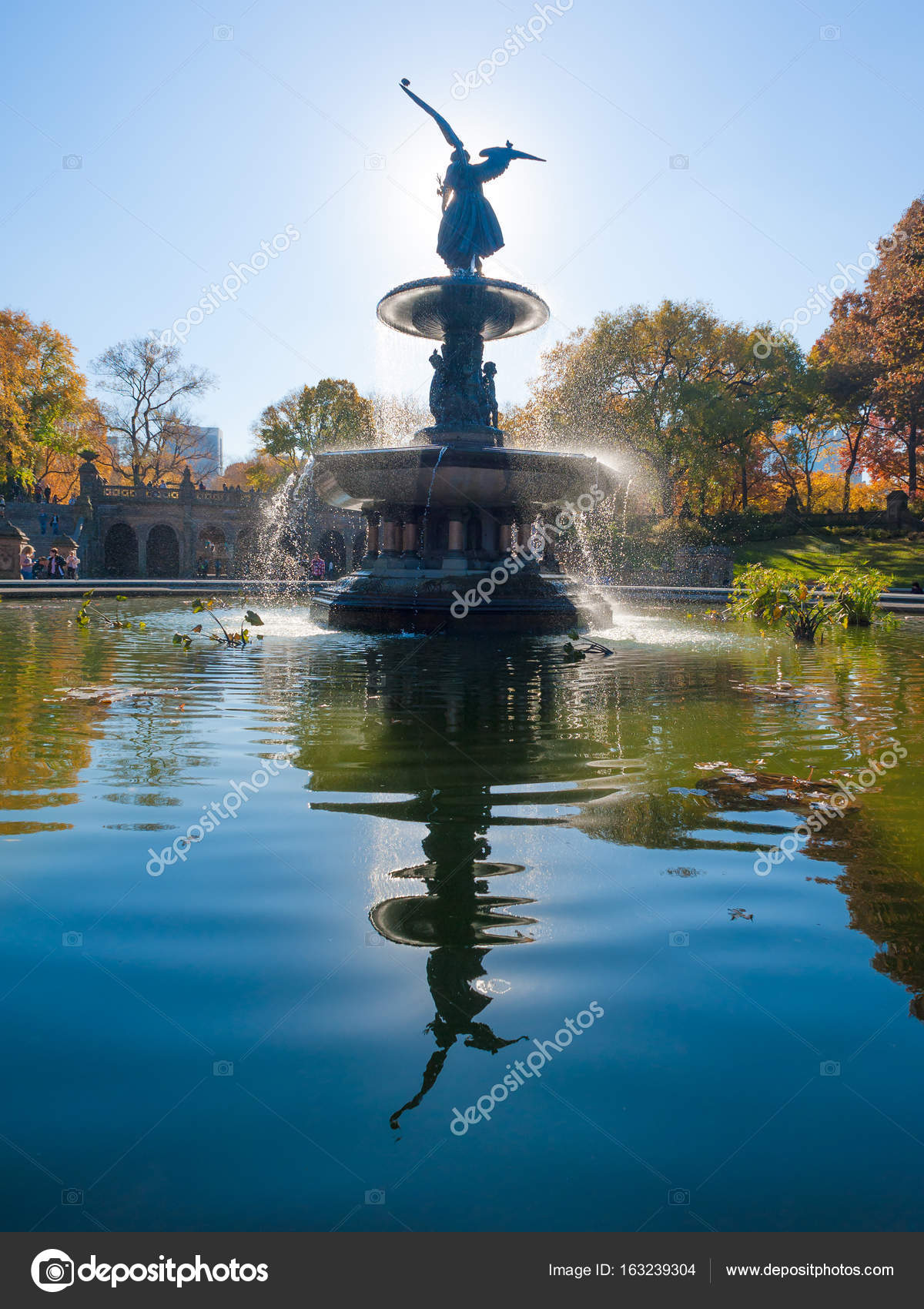 Bethesda Fountain against sun with angel statue reflecting in the ...