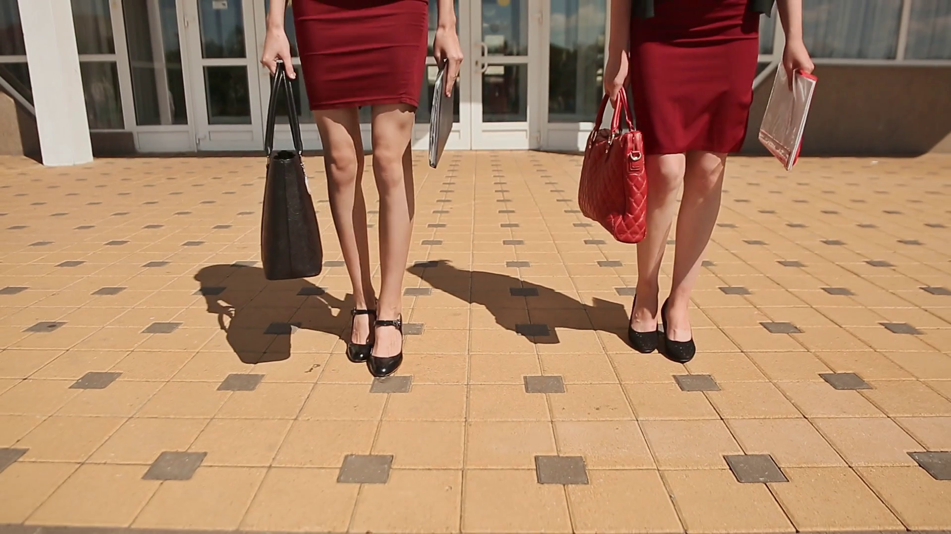 Beautiful young College girls in red skirts walking down the stairs ...