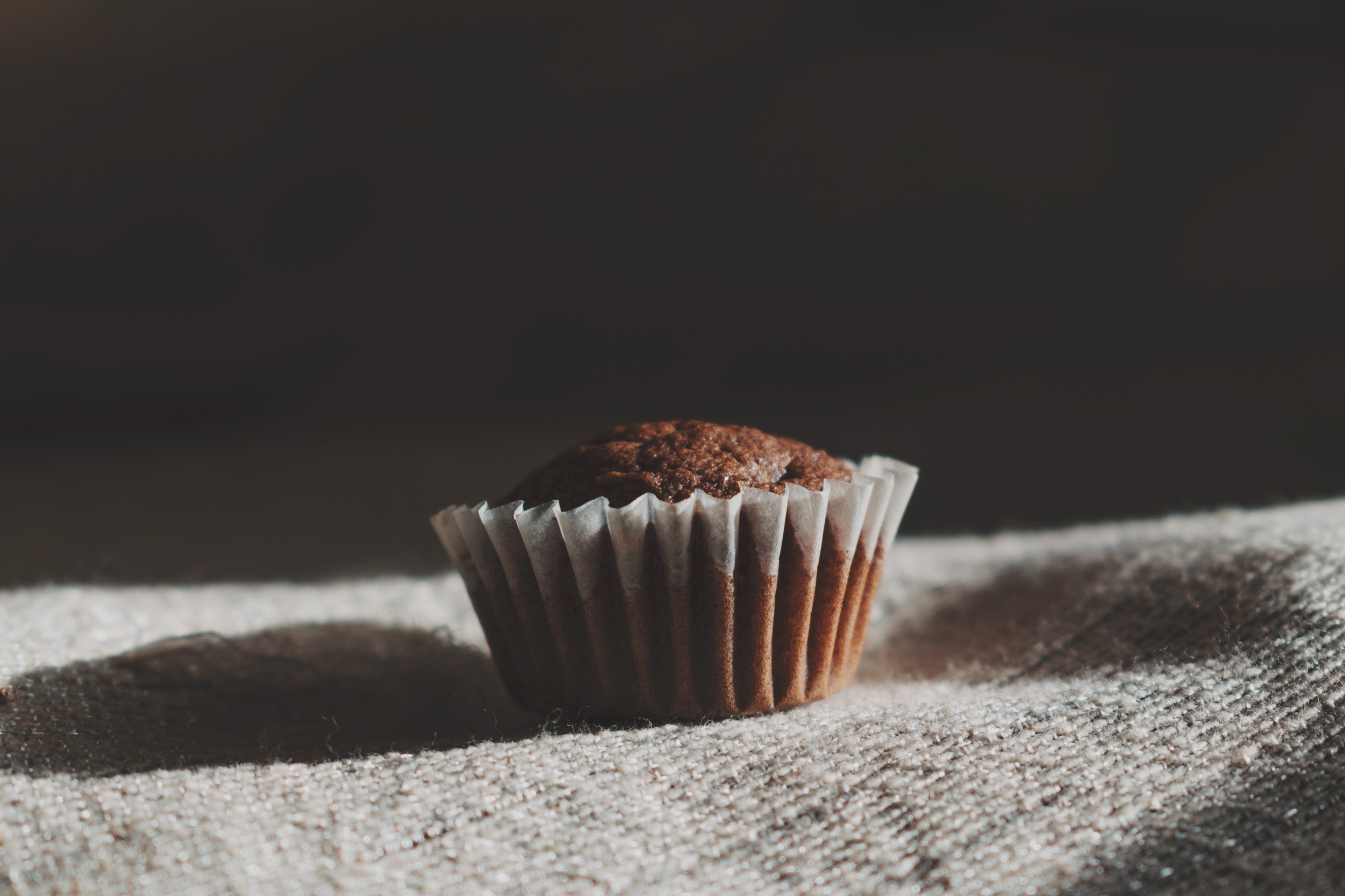 Still life photography of muffin on white textile