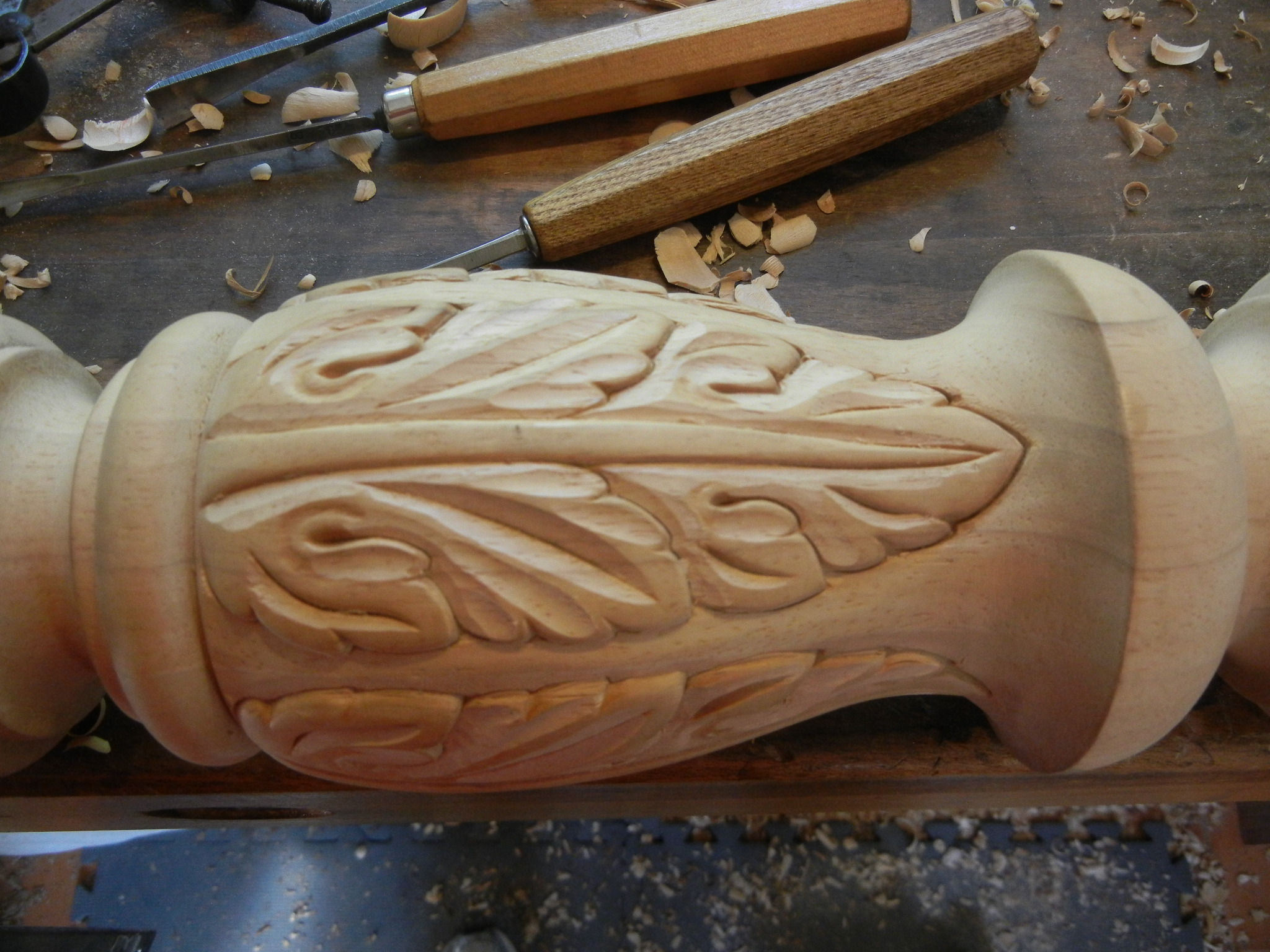 Carving an acanthus leaf on a bed post