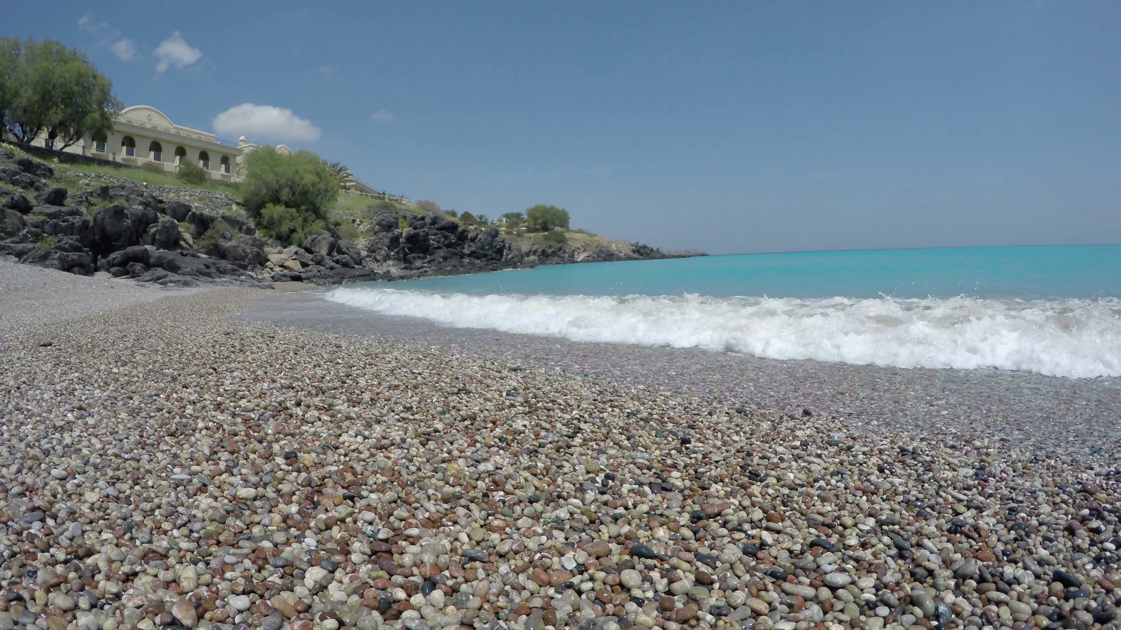 beautiful pebbles stone beach in Lindos resort, Rhodes island ...