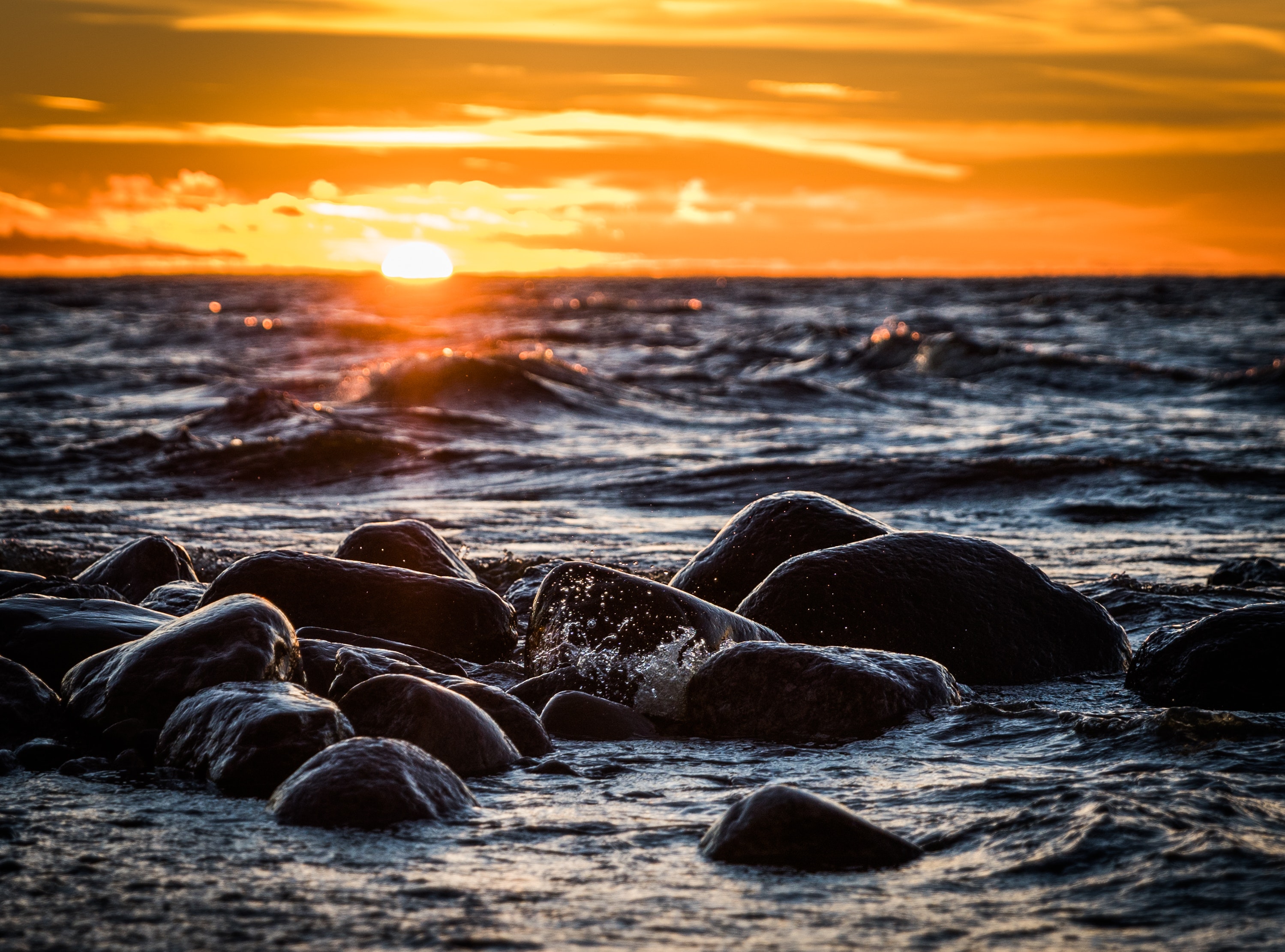 Stones on beach during sunset photo