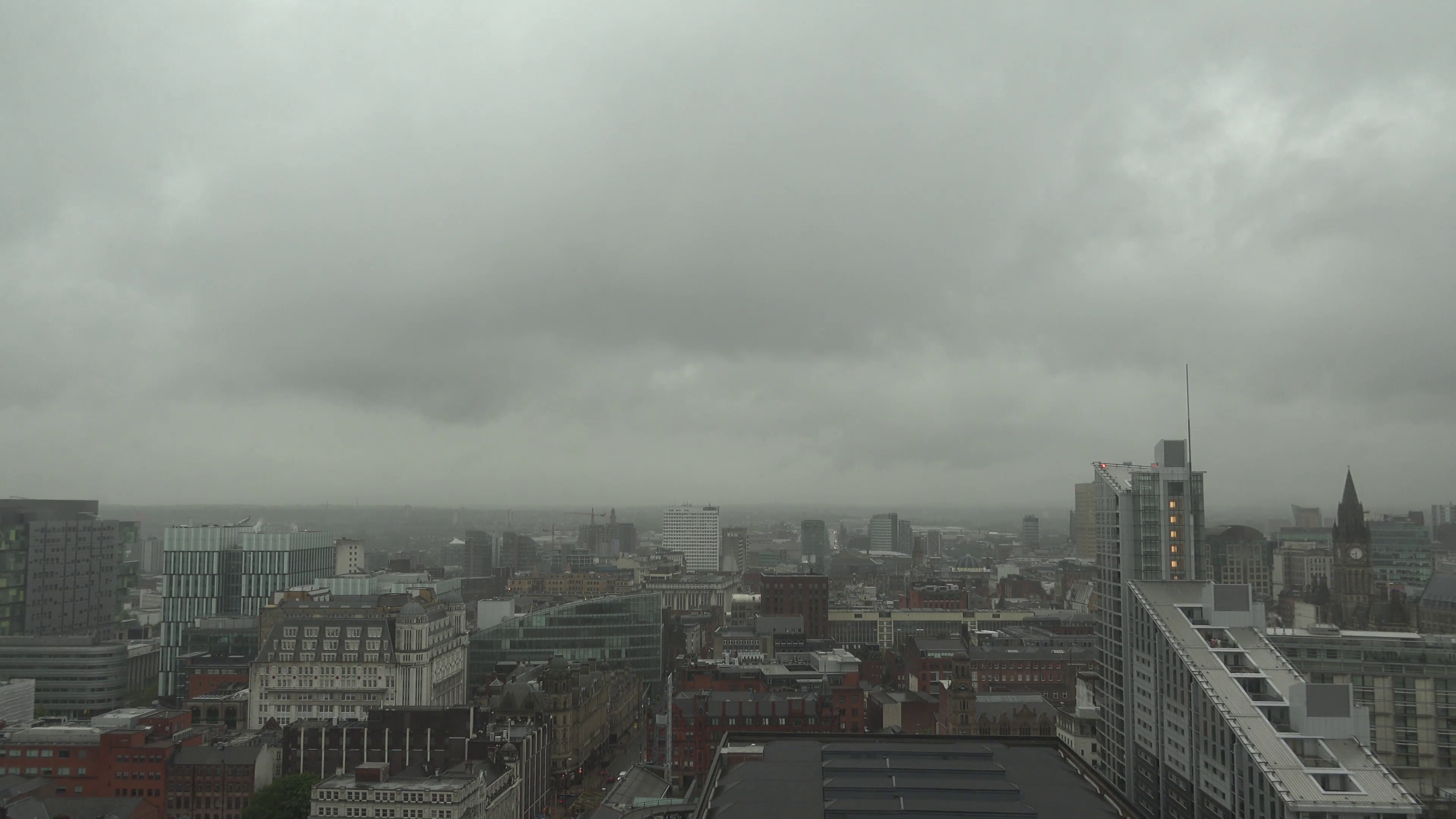 ULTRA HD 4K Aerial view rainy day Manchester skyline storm cloud ...