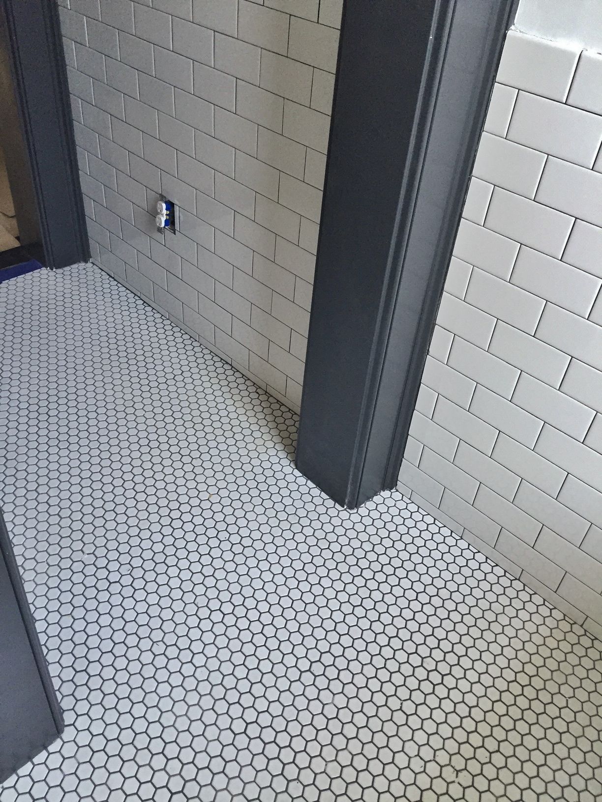 White porcelain hex tile on floor, 3x6 white subway tile on wainscot ...