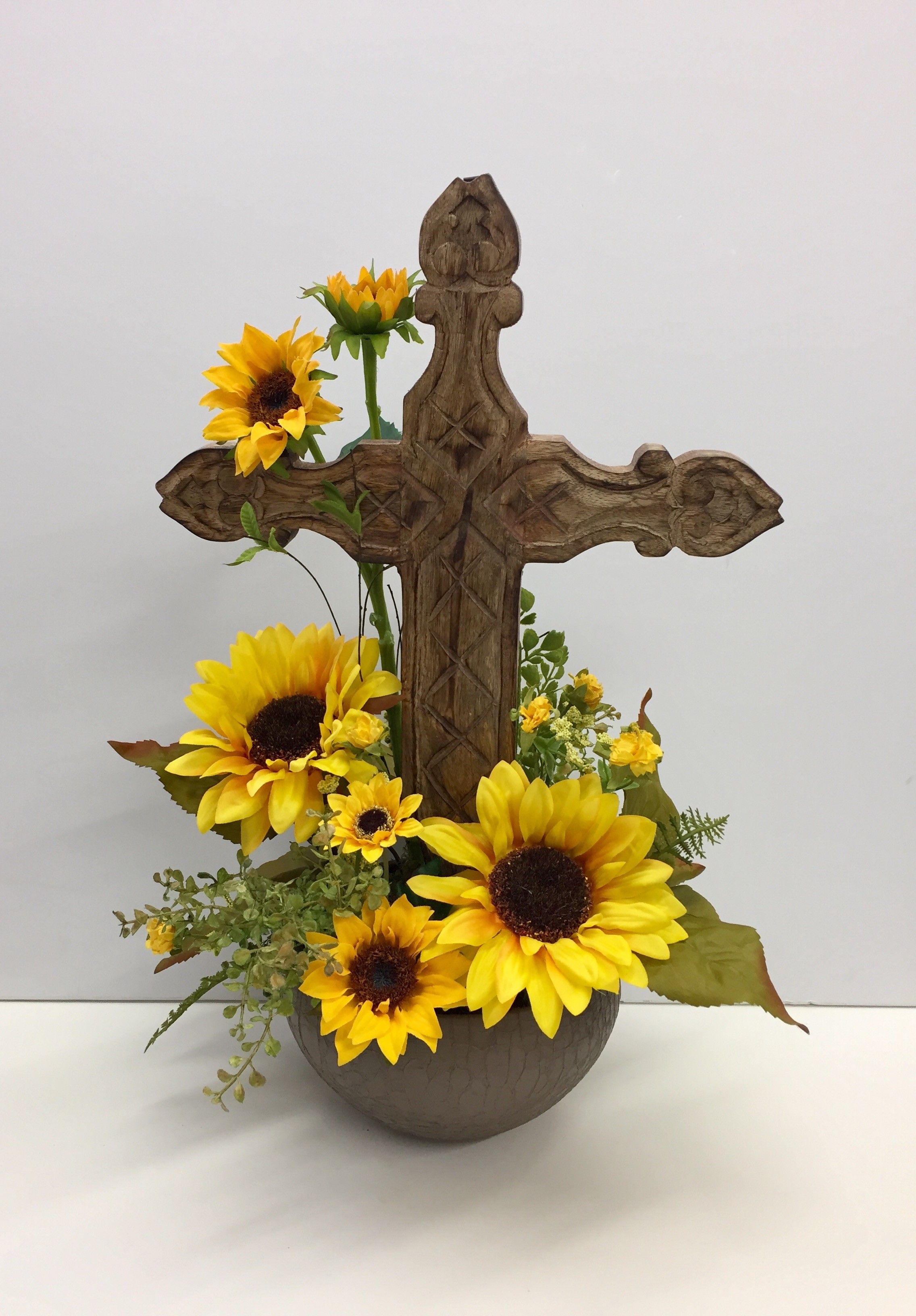 Wooden cross with permanent sunflowers in Pratt, KS | The Flower Shoppe