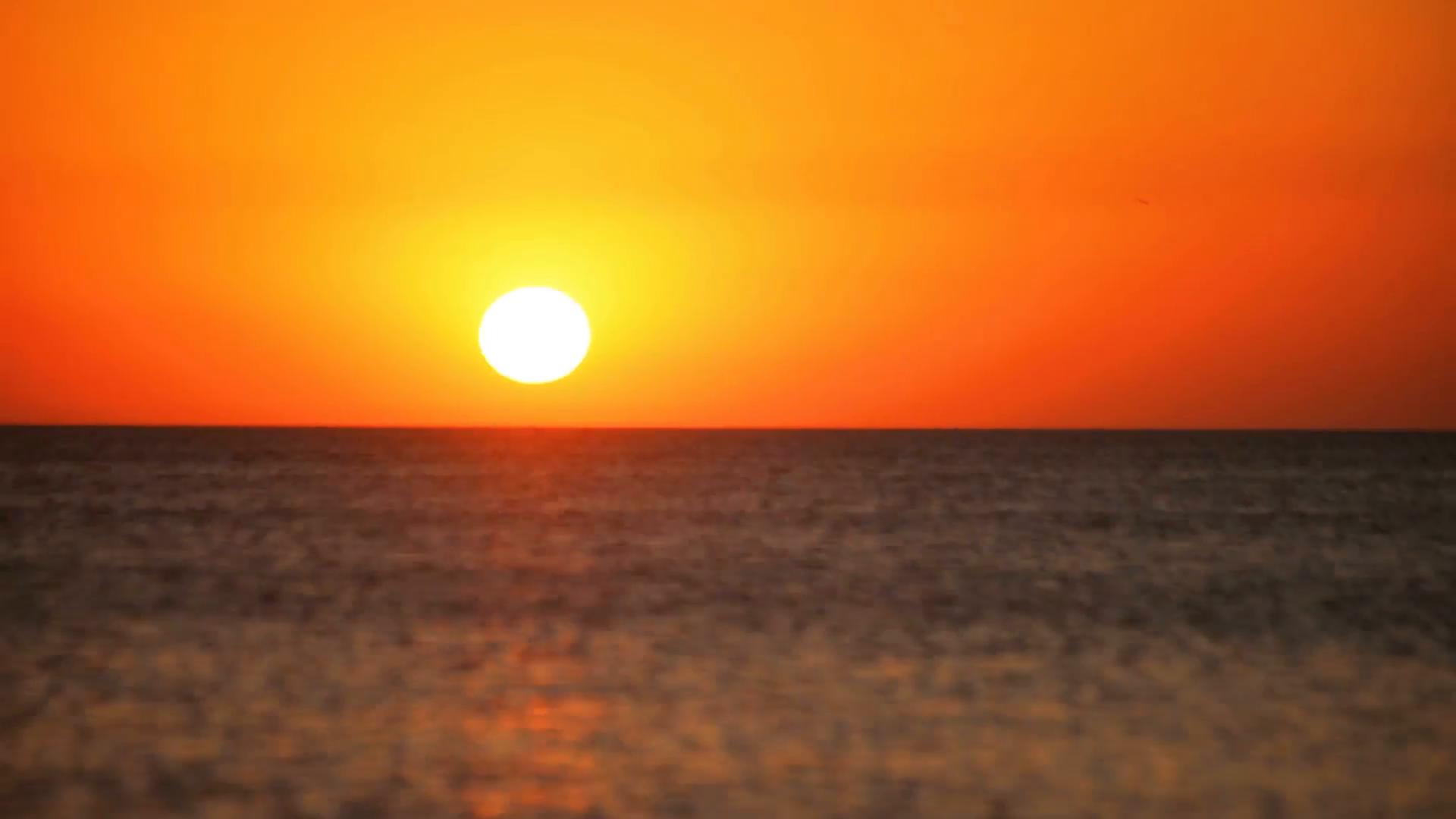 Fast sea sunset time lapse. Sun sets behind sea horizon. Golden ...