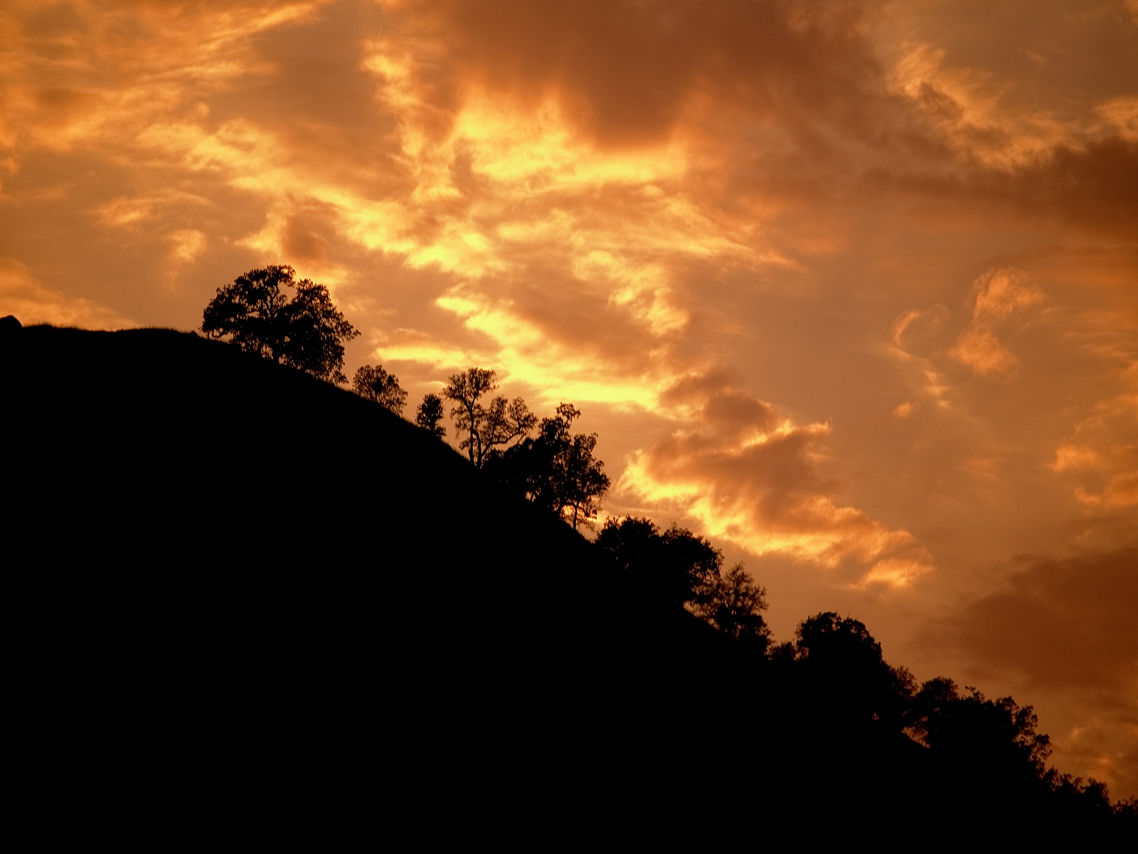 Sunset behind mountain photo