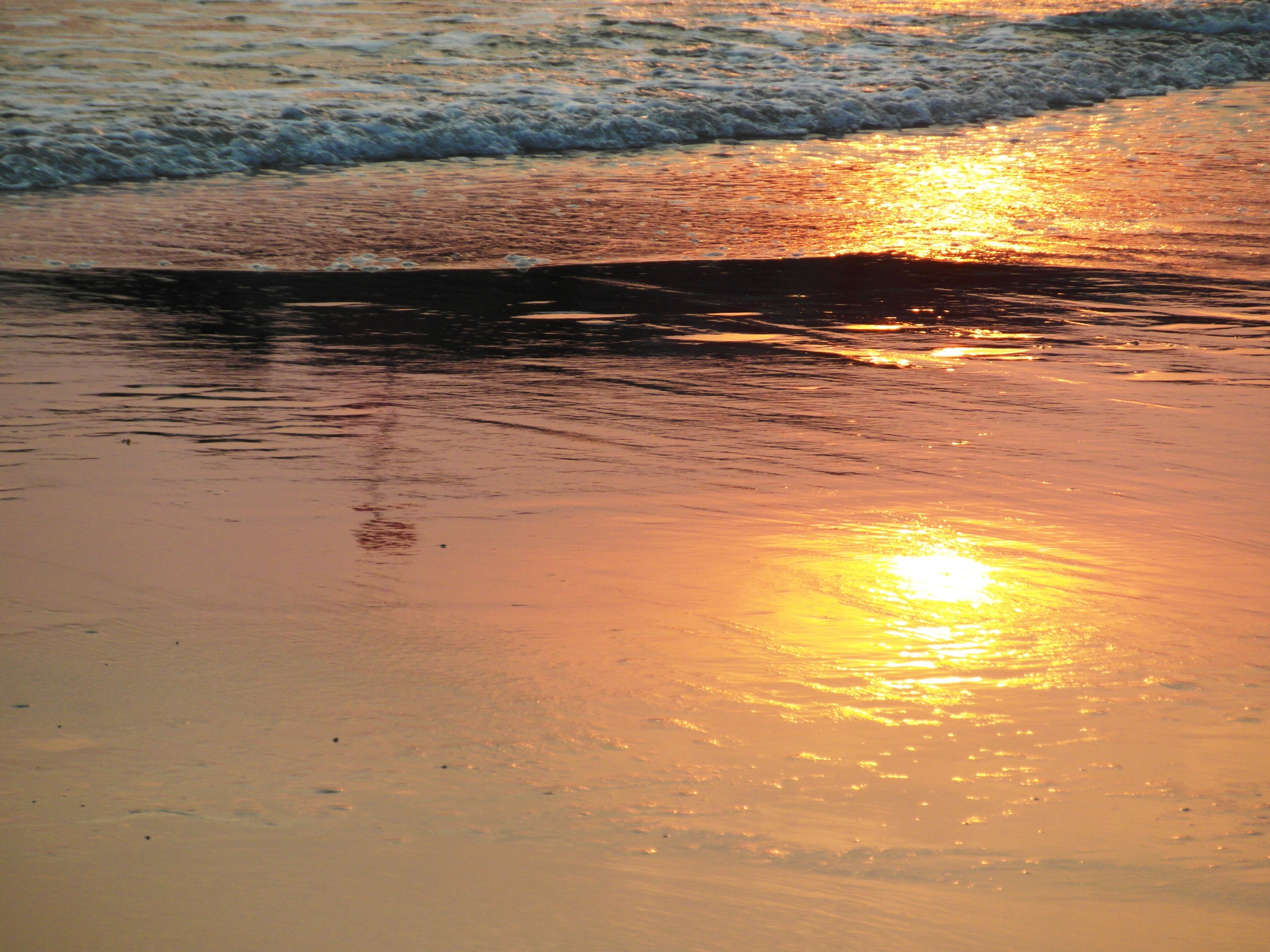 Sunset reflection in the sand photo