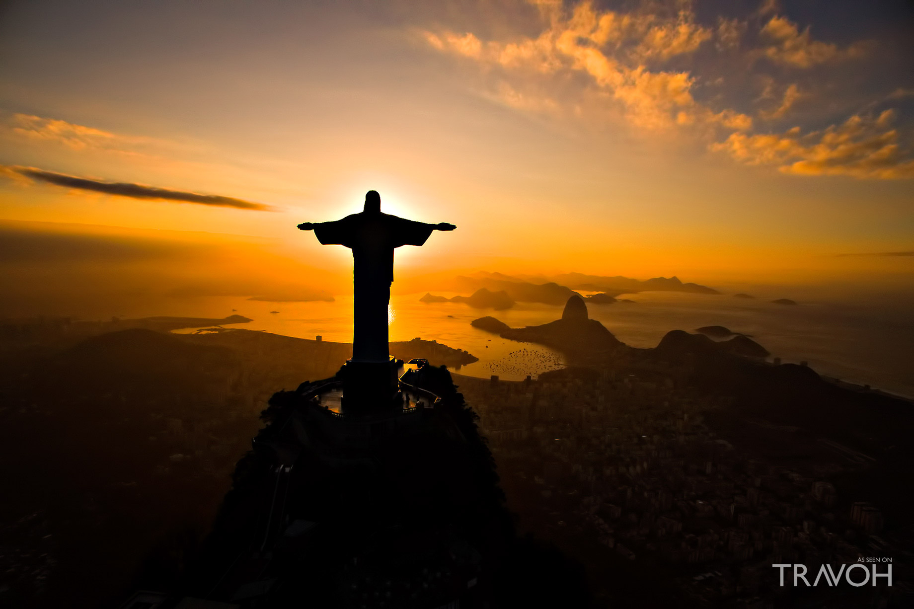 A Dramatic Sunset Illuminates the Statue of Jesus on Top of ...
