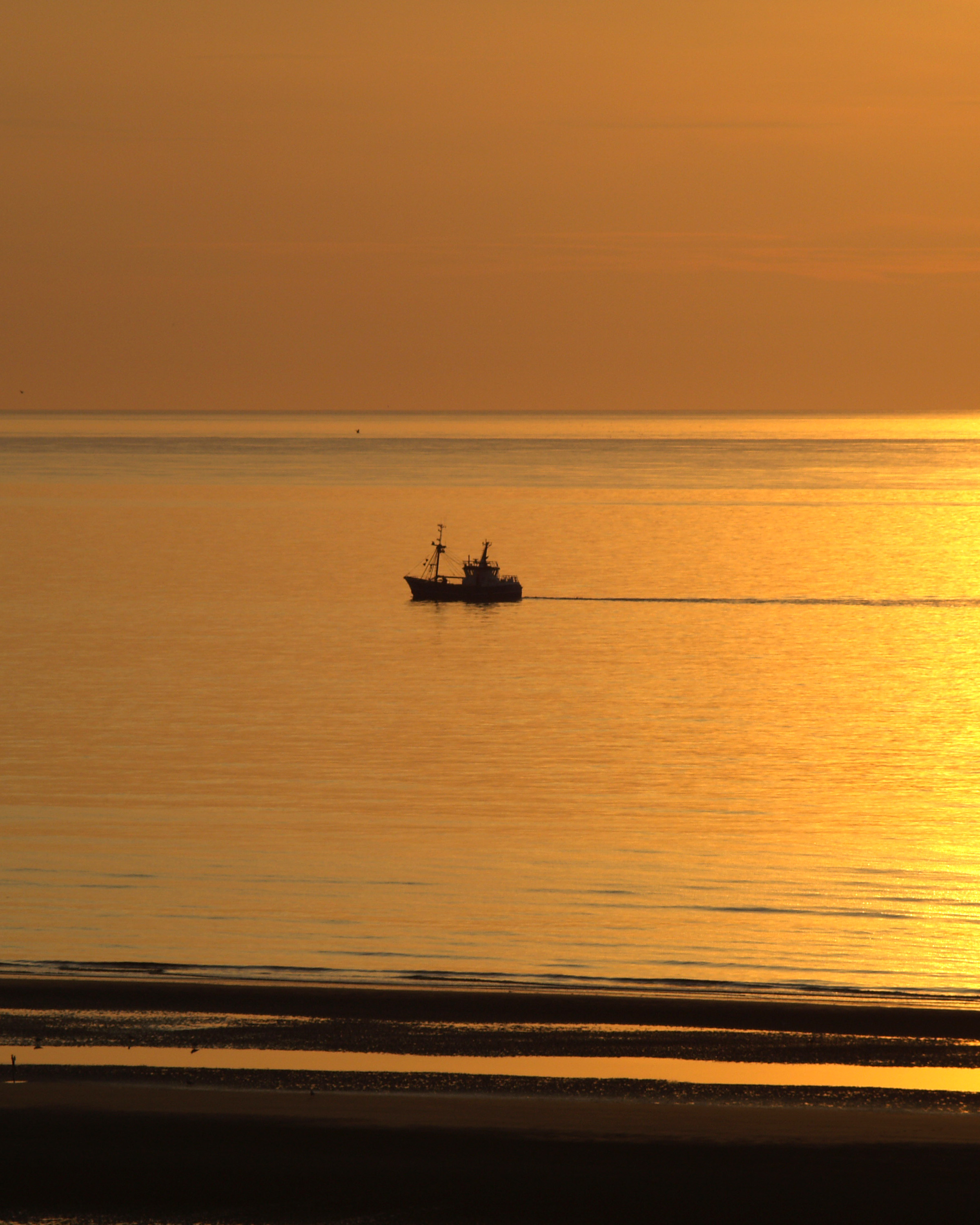 Sunset with fisher boat photo