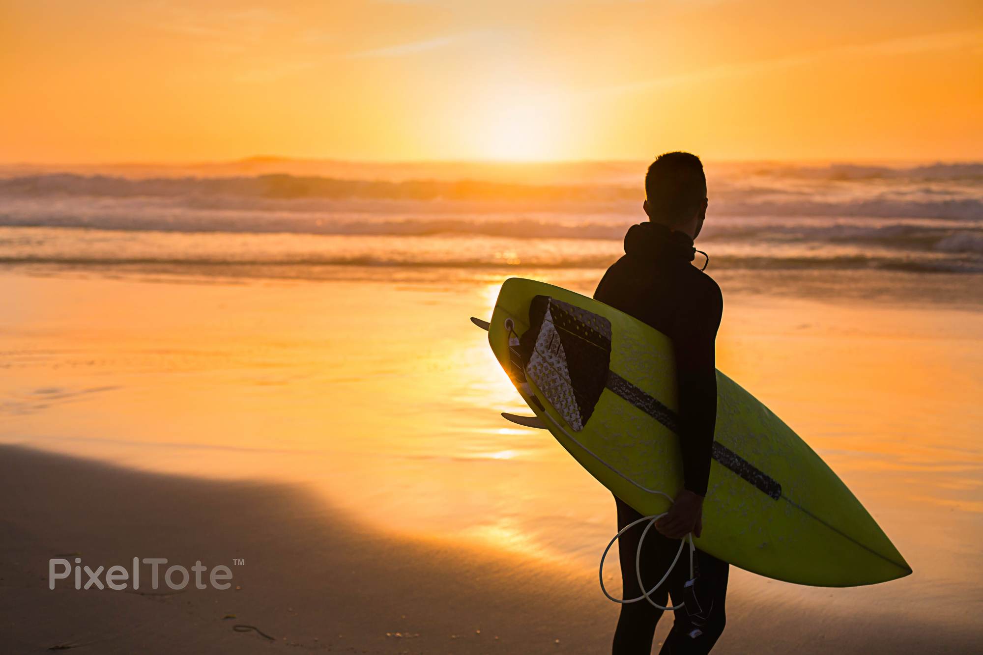 Male Surfer with a Surfboard Standing on a Beach Watching Sunset ...