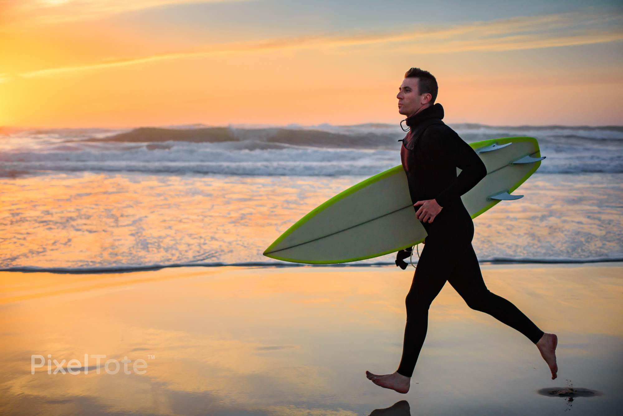 Male Surfer with a Surfboard Running on a Beach During Sunset Stock ...