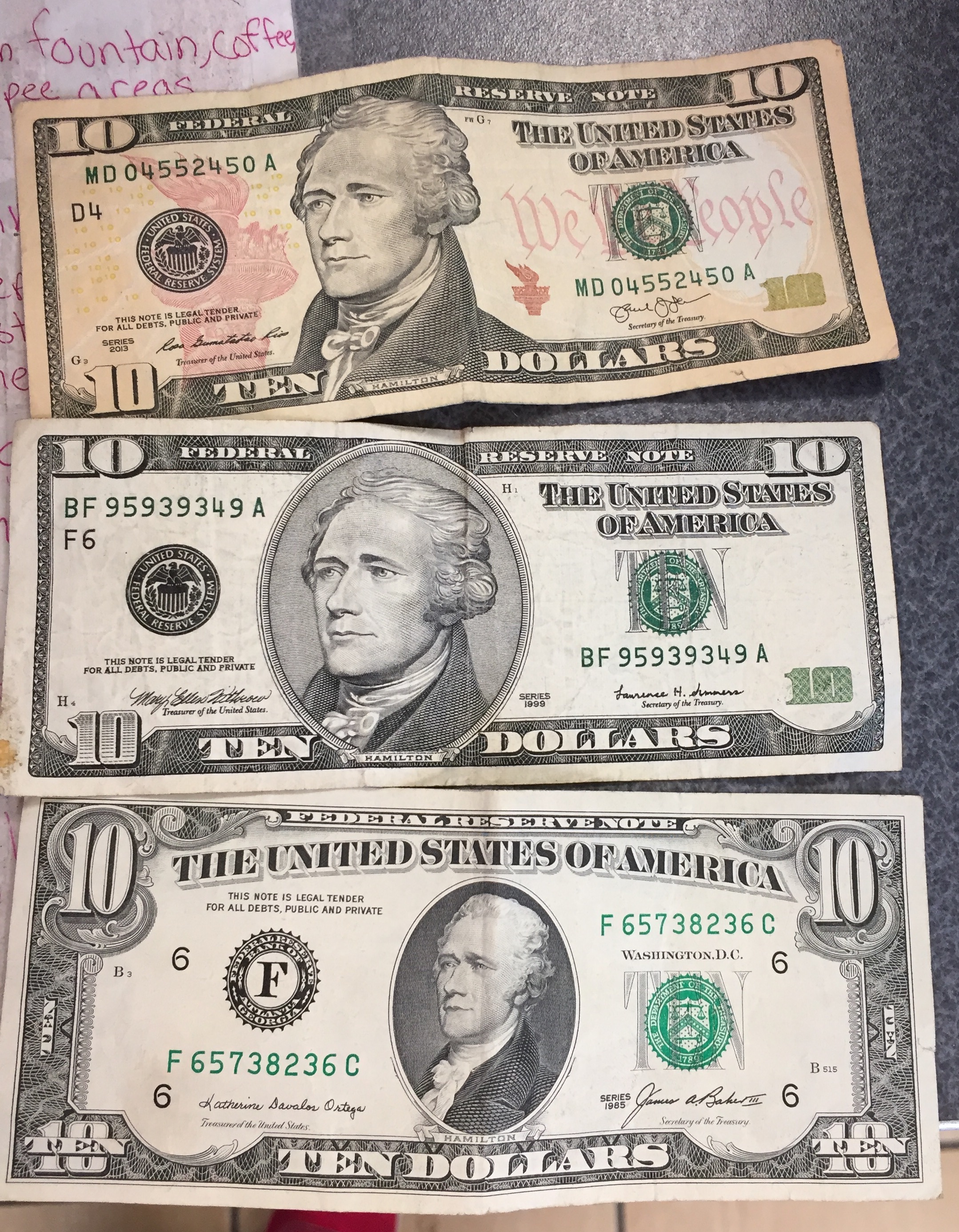 Three ten dollar bills from three different decades (1985, 1999 ...