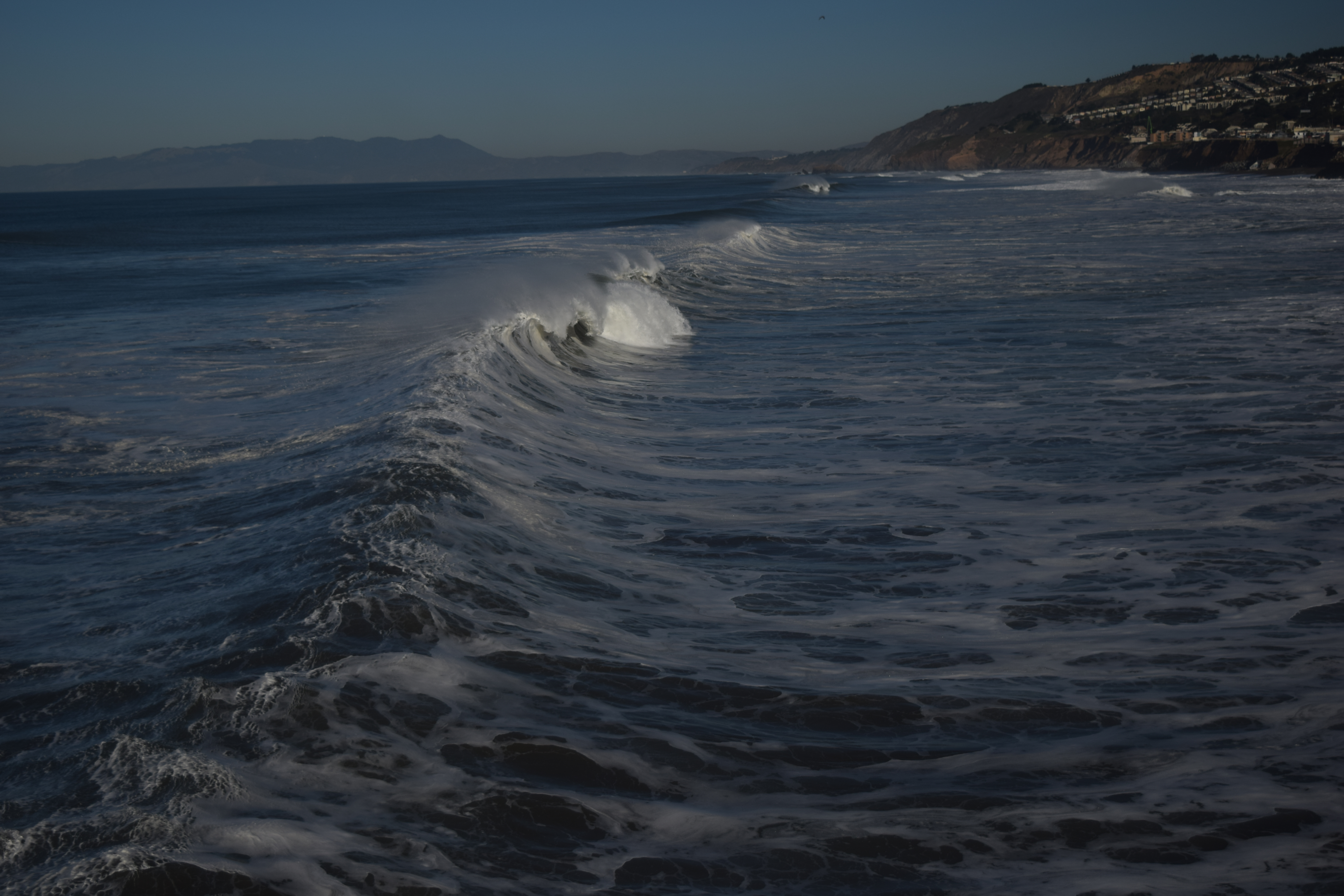 The crashing waves of pacifica pier photo