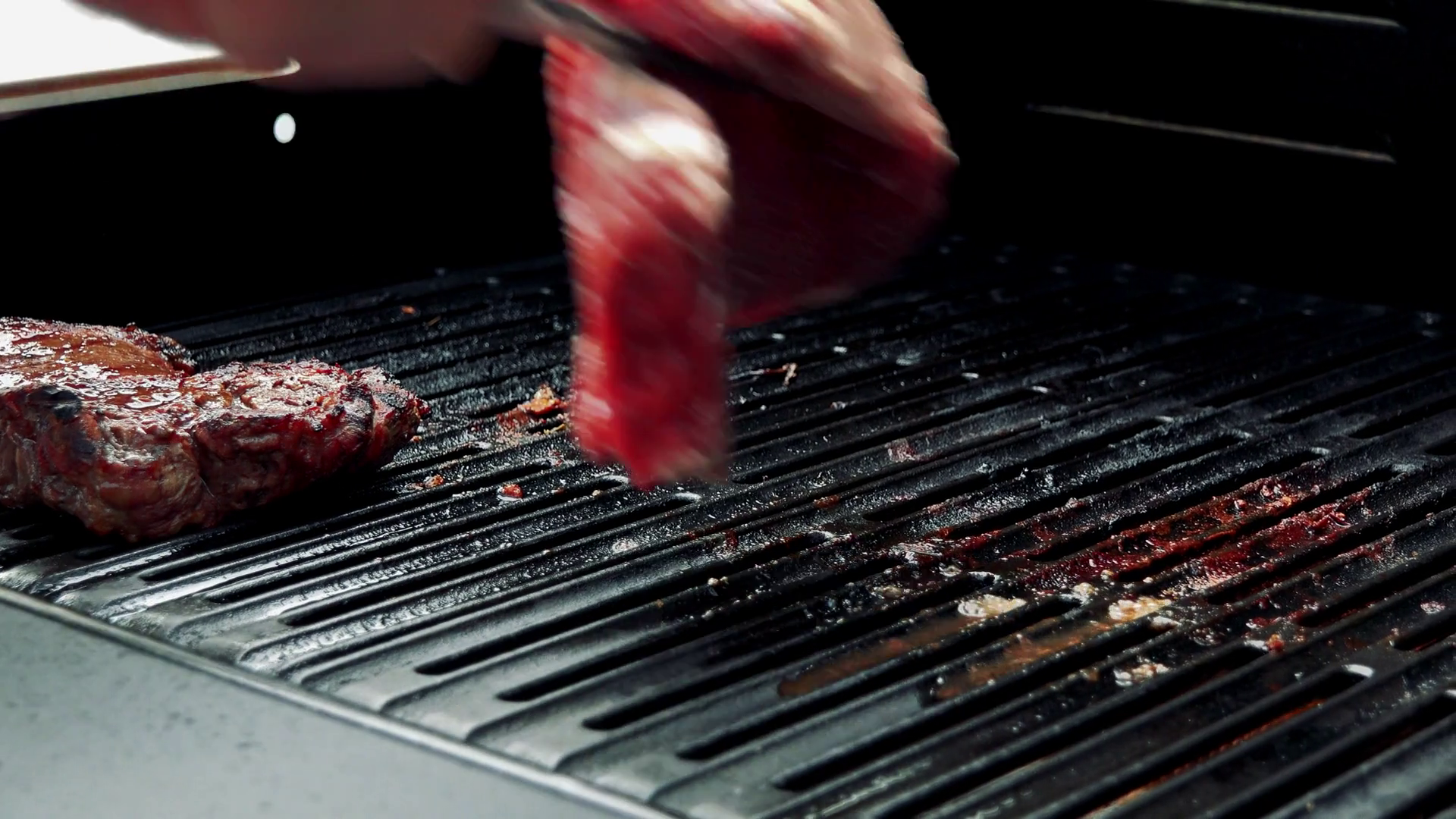 man prepares meat (beef and chicken) on the grill - man put raw meat ...