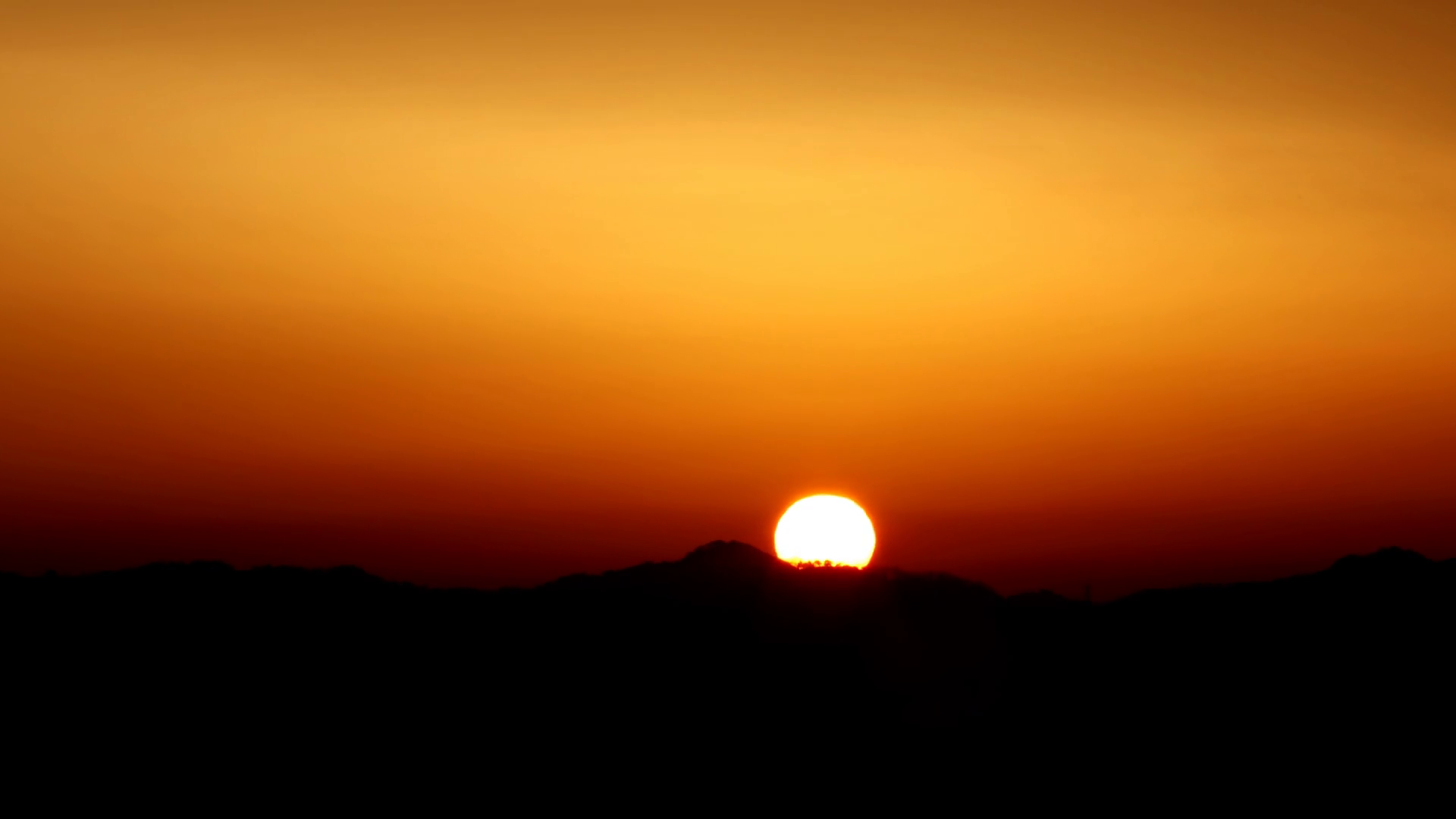 Time lapse of beautiful sun rising over mountain and hiding behind ...