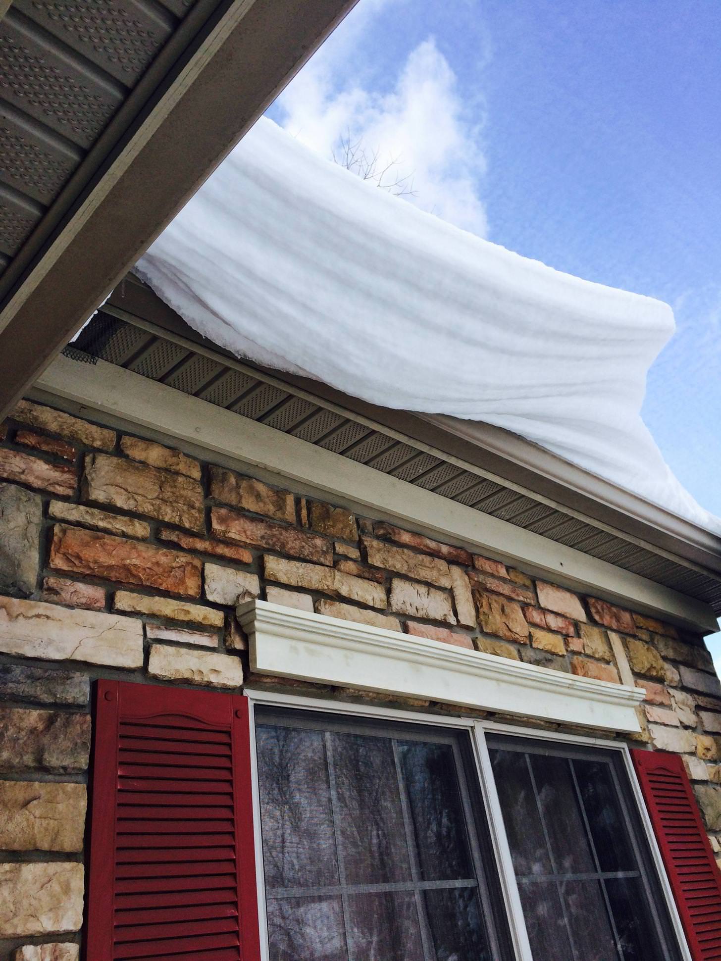 The melting snow on the roof caused a snow shelf - Imgur
