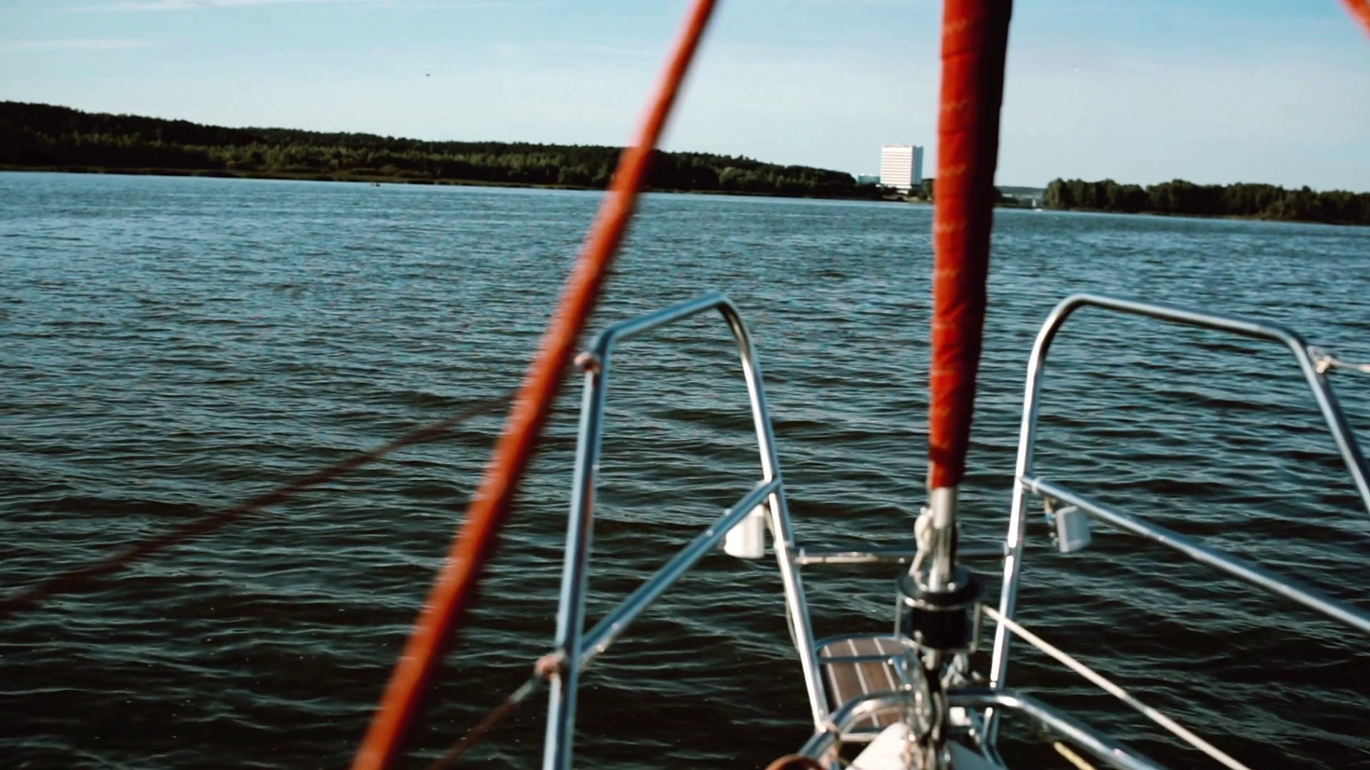Nasal part of the sailboat goes through the waves in lake. Sailing ...