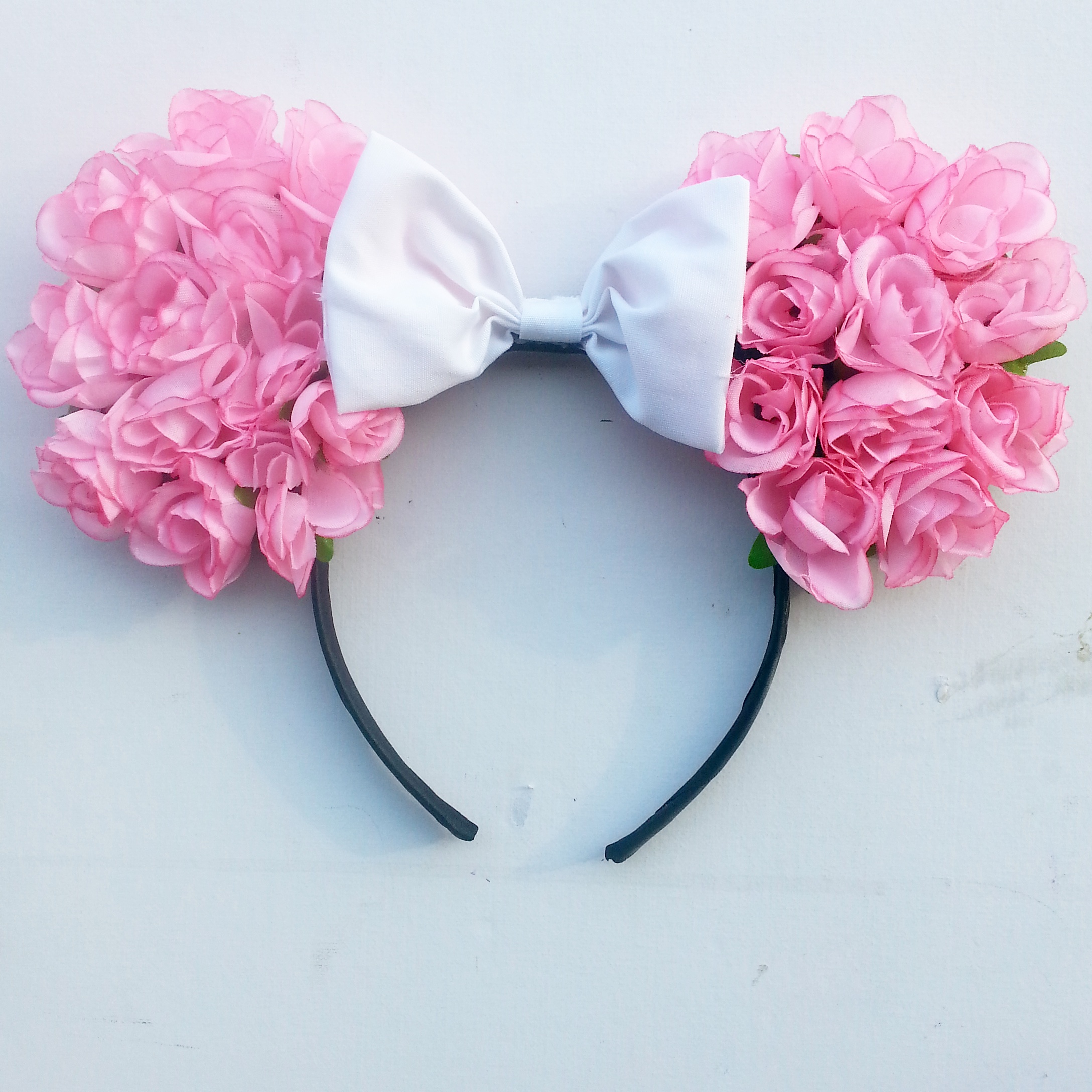 These ears are made using pink silk roses and complimented with a ...