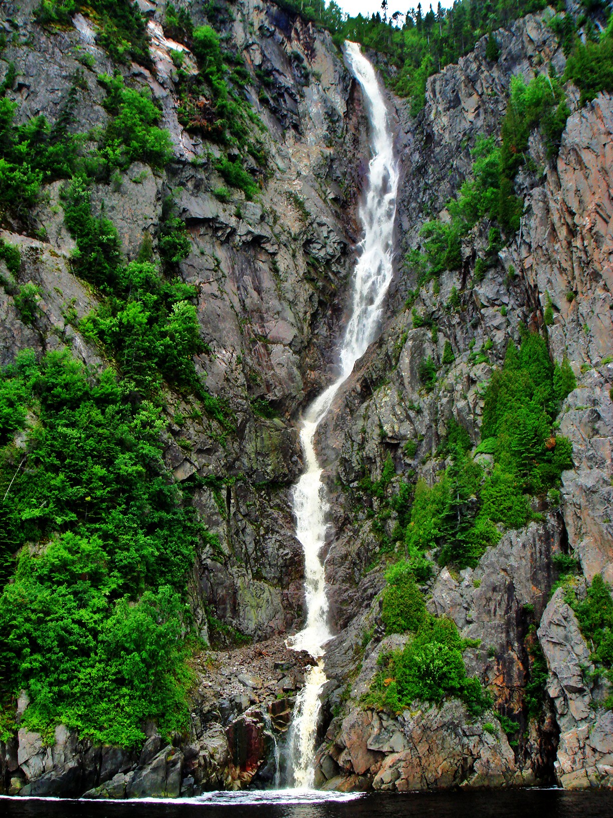 File:High and thin waterfall flowing into sea - panoramio.jpg ...