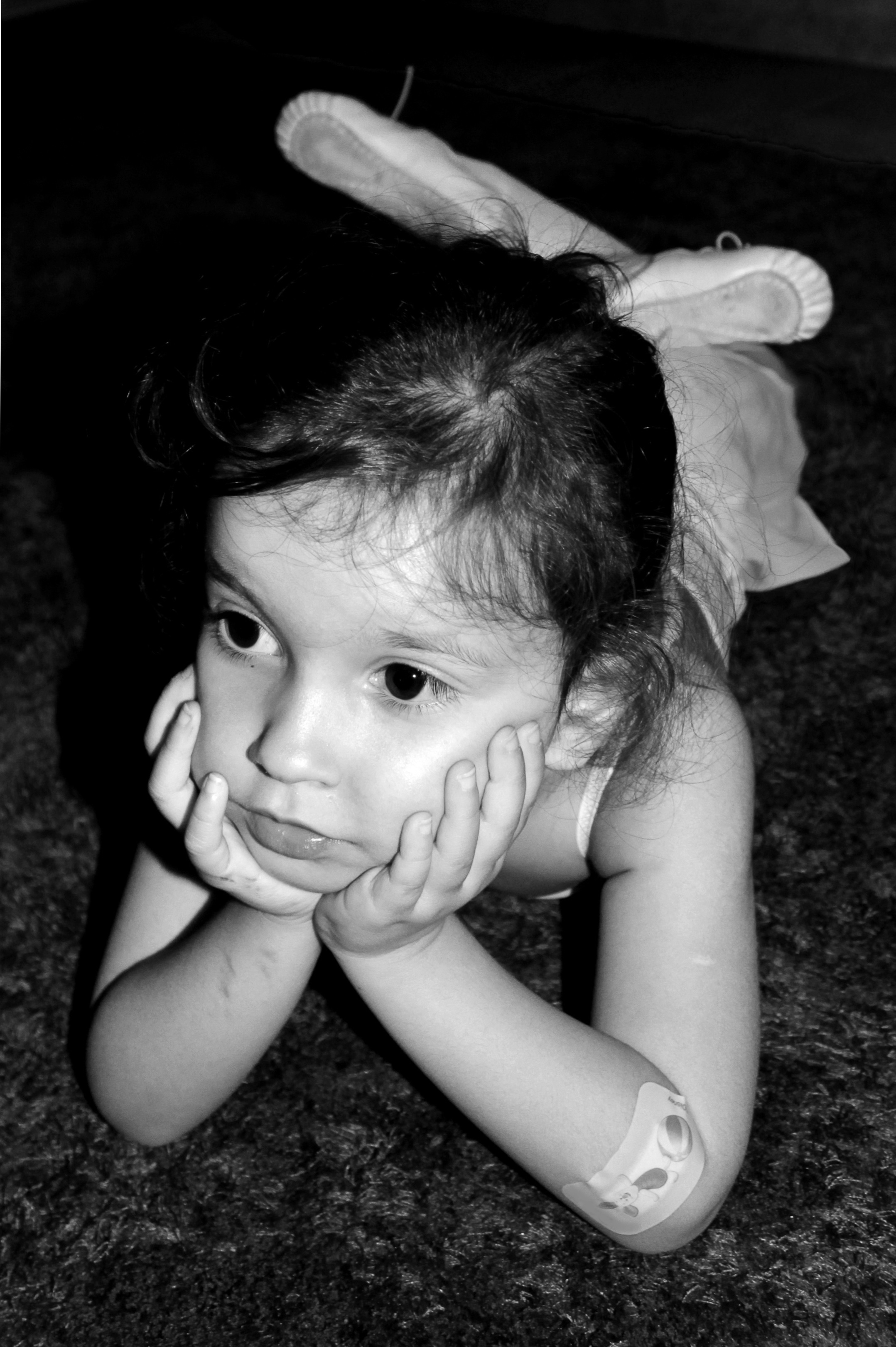 Thoughtful young ballerina with a band aid on the elbow photo
