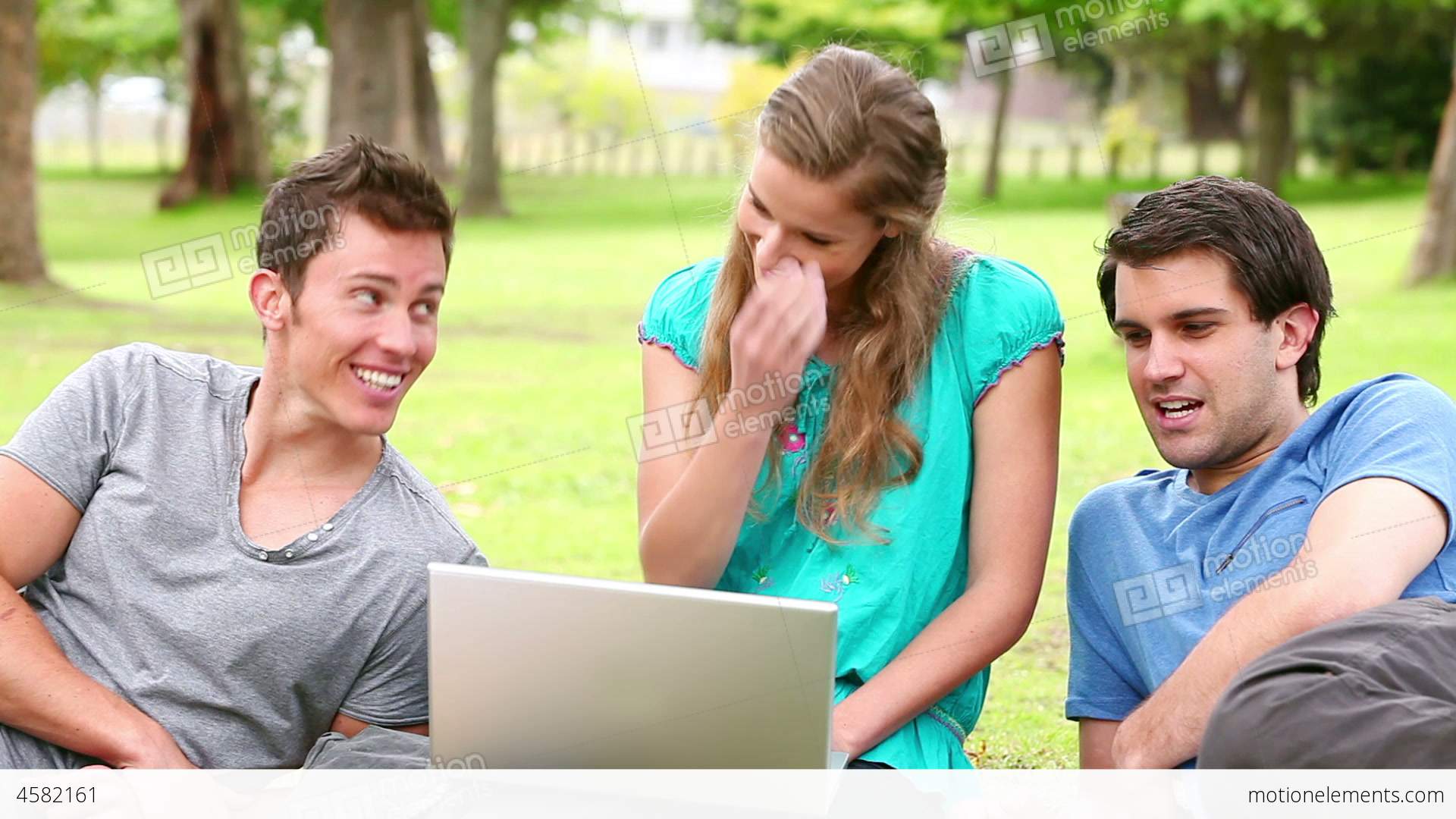 Three Friends Talking While Looking At A Laptop As Stock video ...