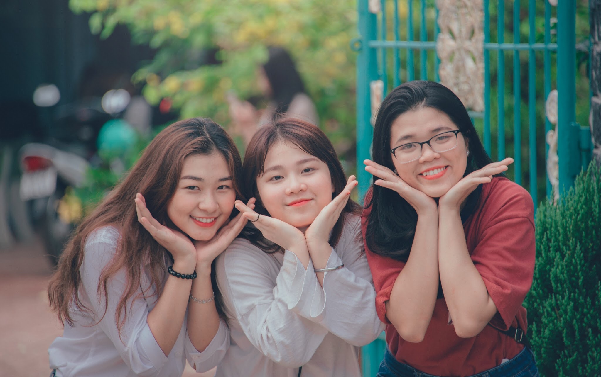 Three girl's wearing white and red dress shirts photo