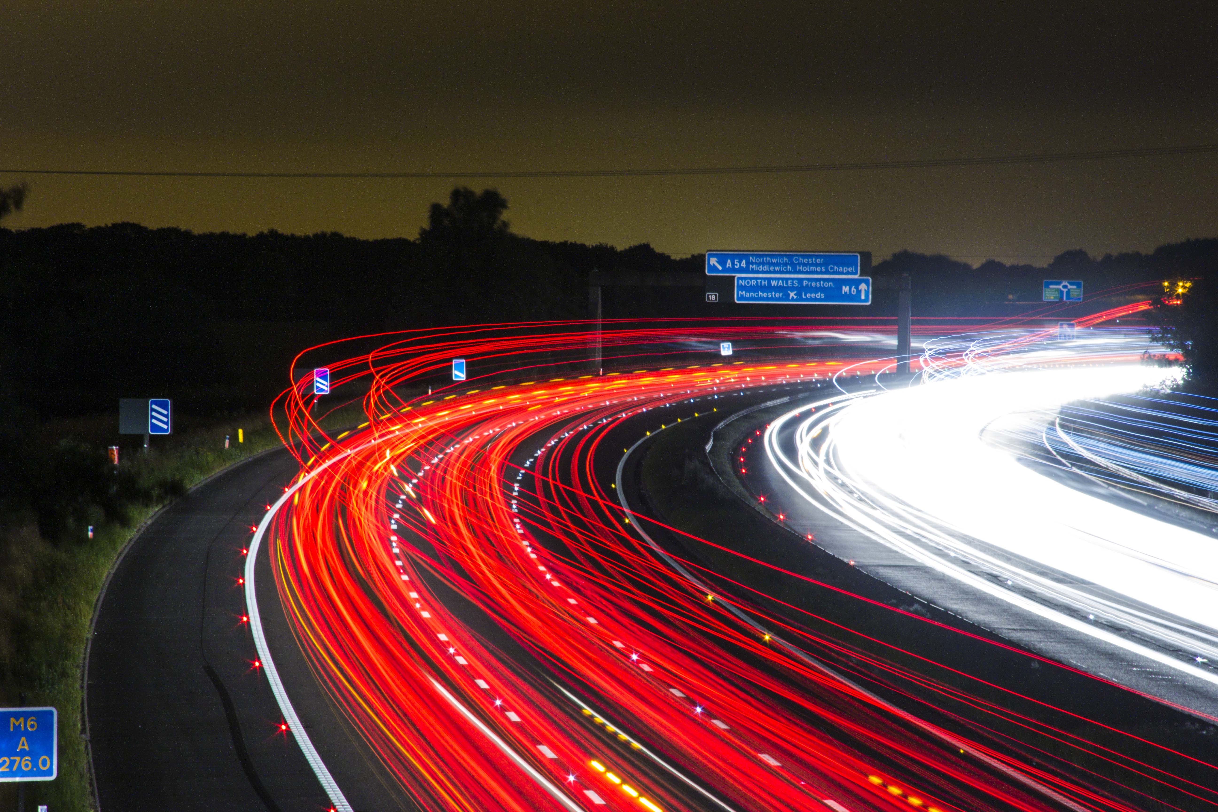 Time lapse photography of car passing by the winding road during nighttime