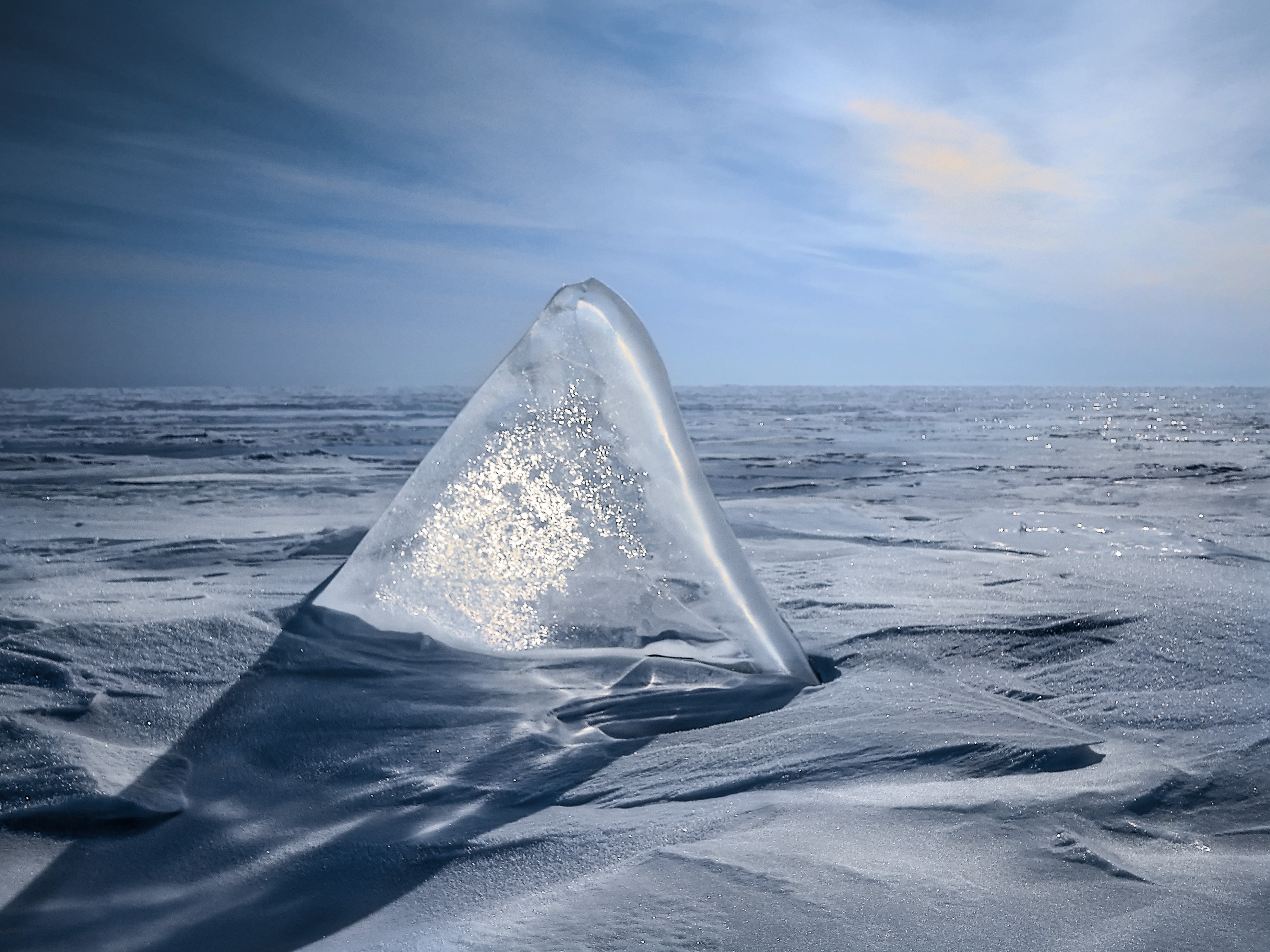 Triangular ice in sand photo
