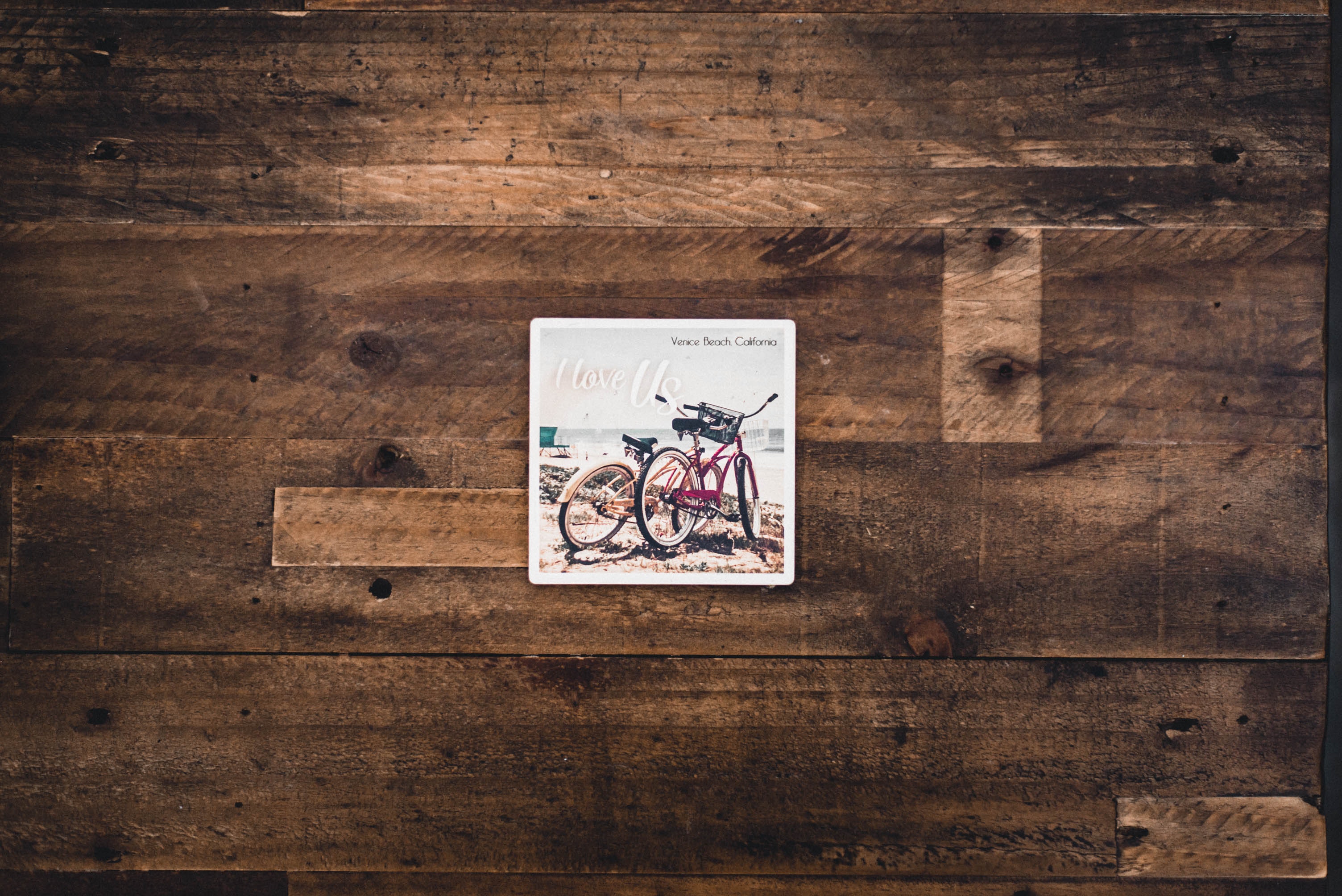 Two assorted bicycles illustration on brown wooden surface photo